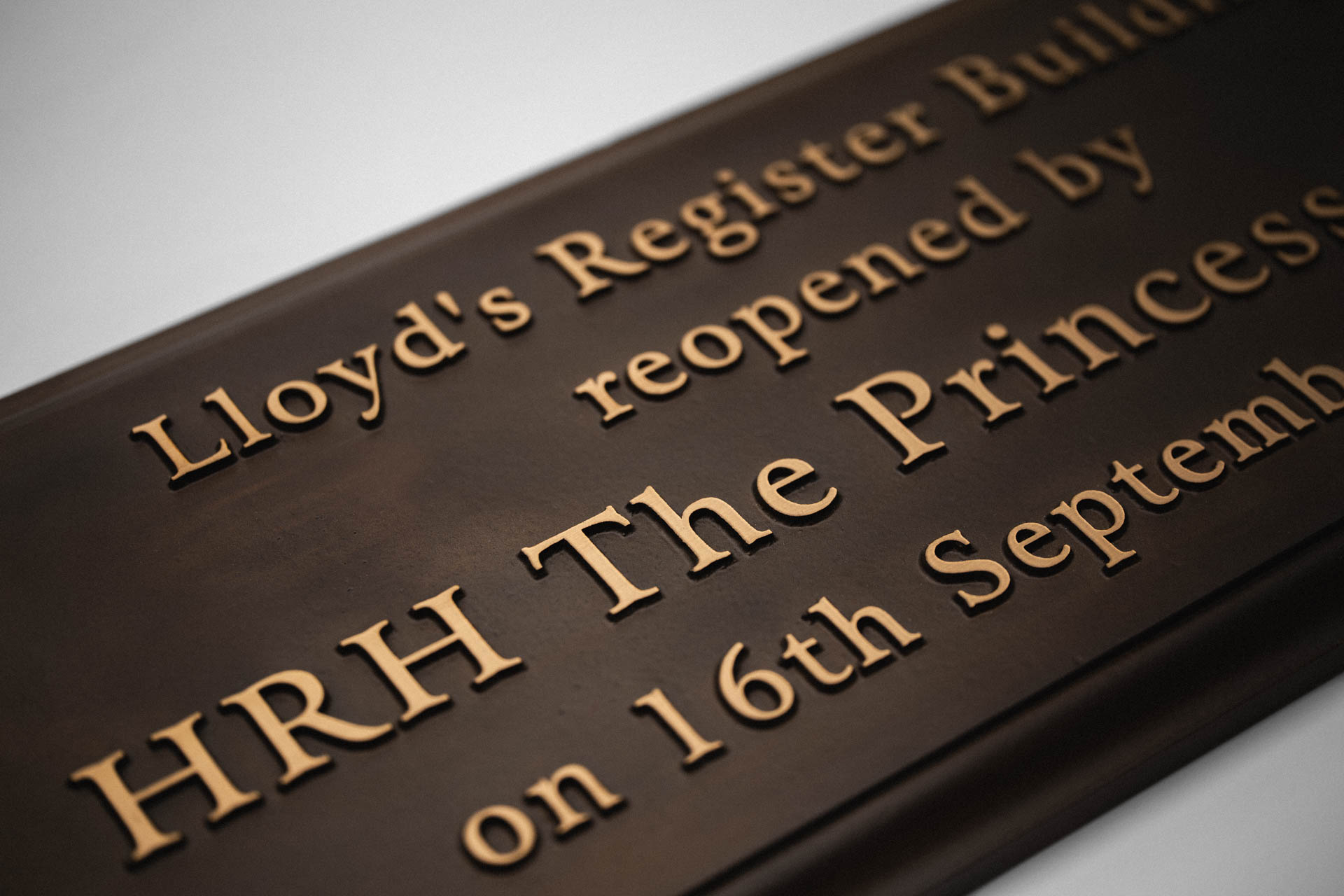Close-up showing the completed bronze commemorative plaque, featuring raised lettering on a patinated background, created for the Lloyd’s Register building re-opening.
