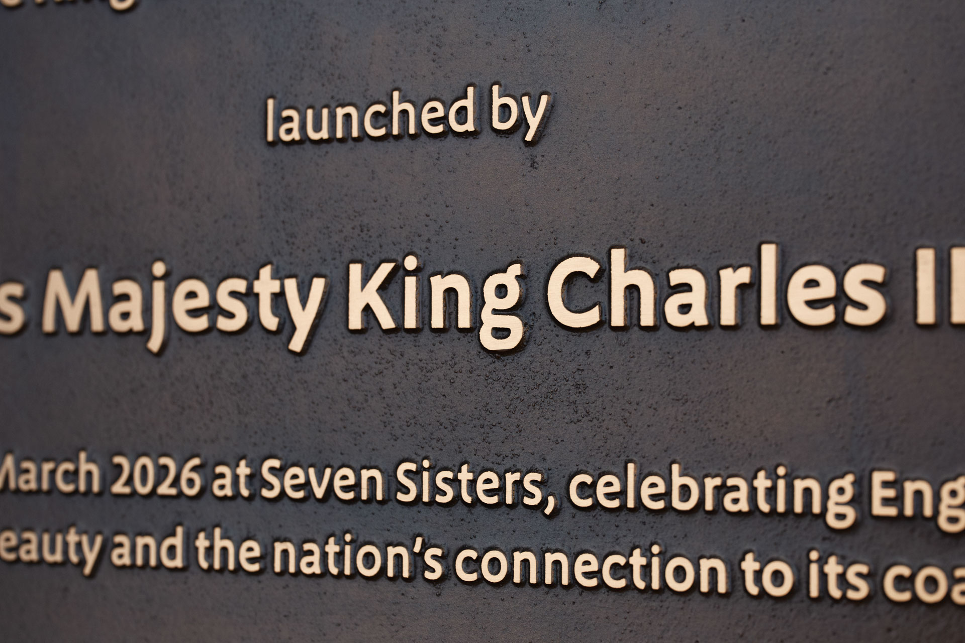 Cast bronze commemorative plaque for King Charles III at Seven Sisters. Designed and produced with Natural England for a lasting coastal installation.