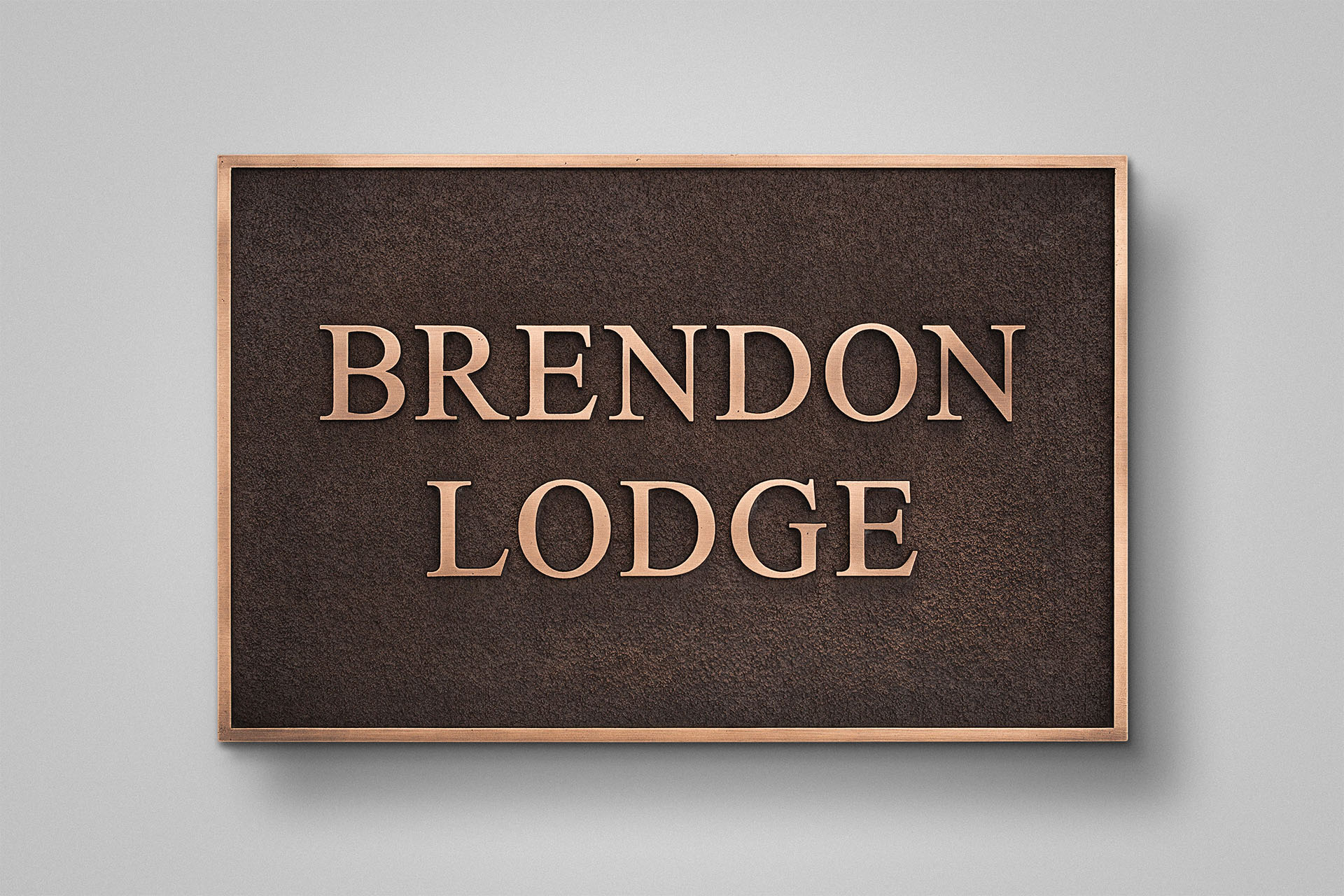 Custom cast bronze house sign with polished bronze lettering and a traditional dark patina.