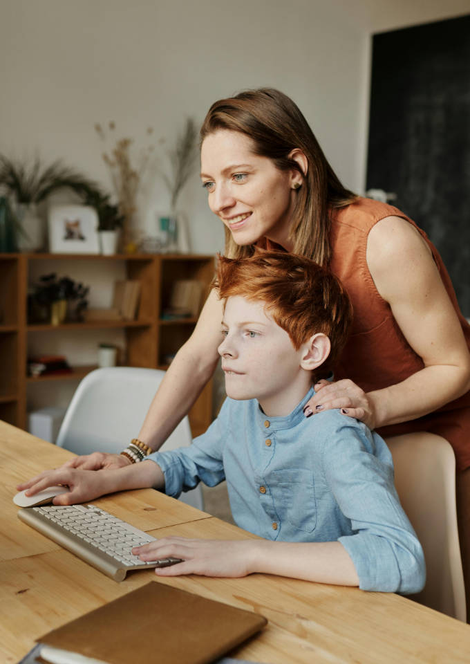 Woman helping a kid study
