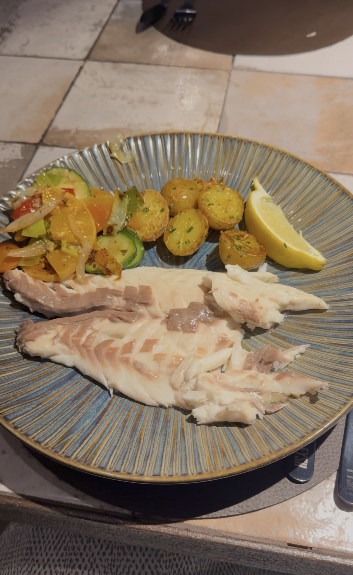 Grilled bacalhau (salt cod) with roasted potatoes and salad — a classic Portuguese meal