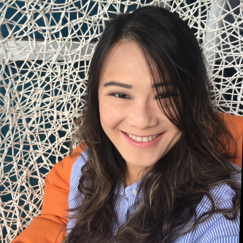 Hilda smiling in front of a camera