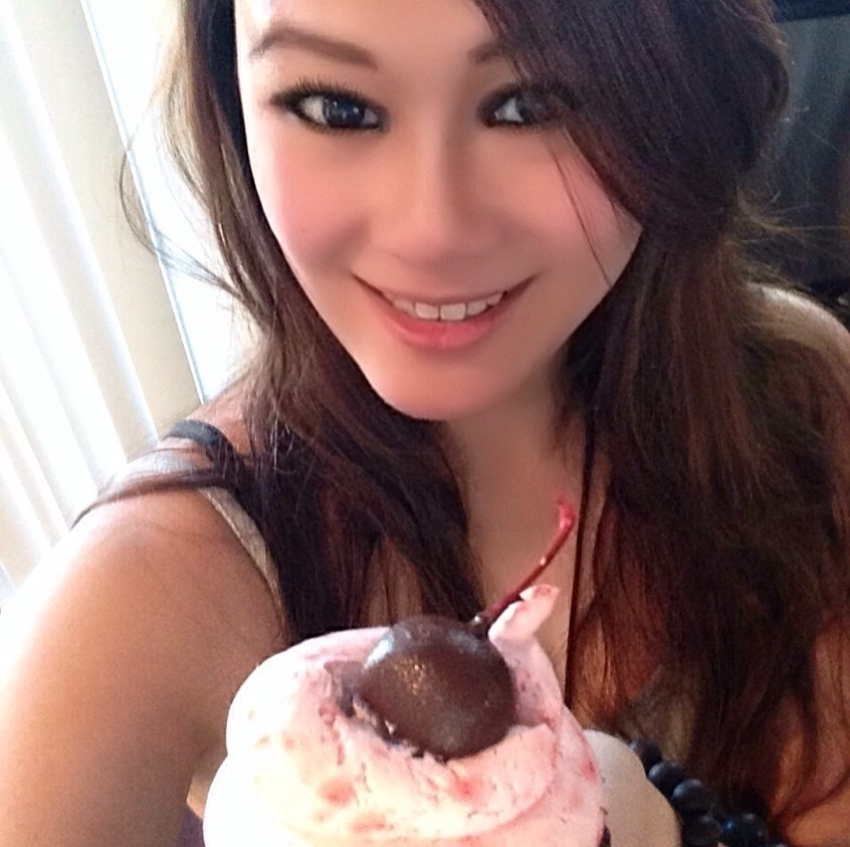 A girl holding a cupcake