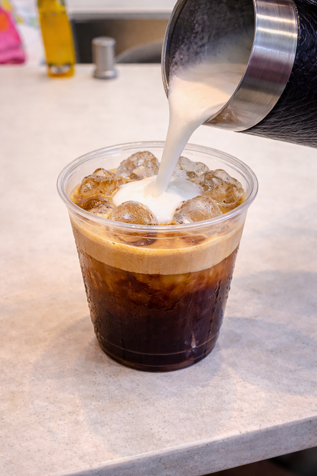 pour froth milk to ice espresso