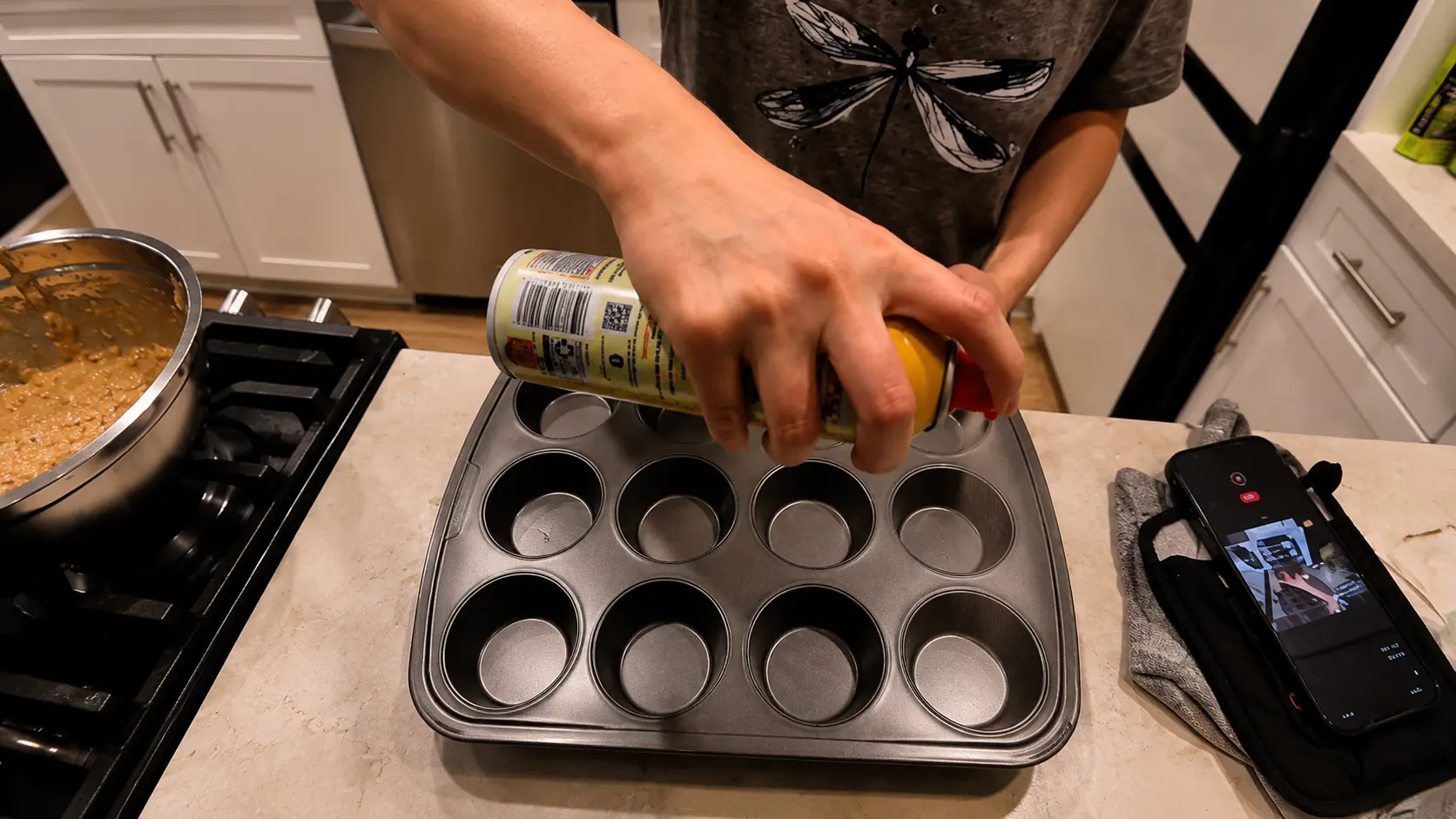 spraying the muffin pan