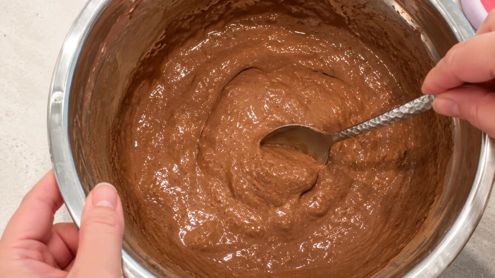 Chocolate brownie batter for flourless high protein brownies made with banana, eggs, Greek yogurt, cocoa powder, and honey. The batter is thick, smooth, and ready for baking.