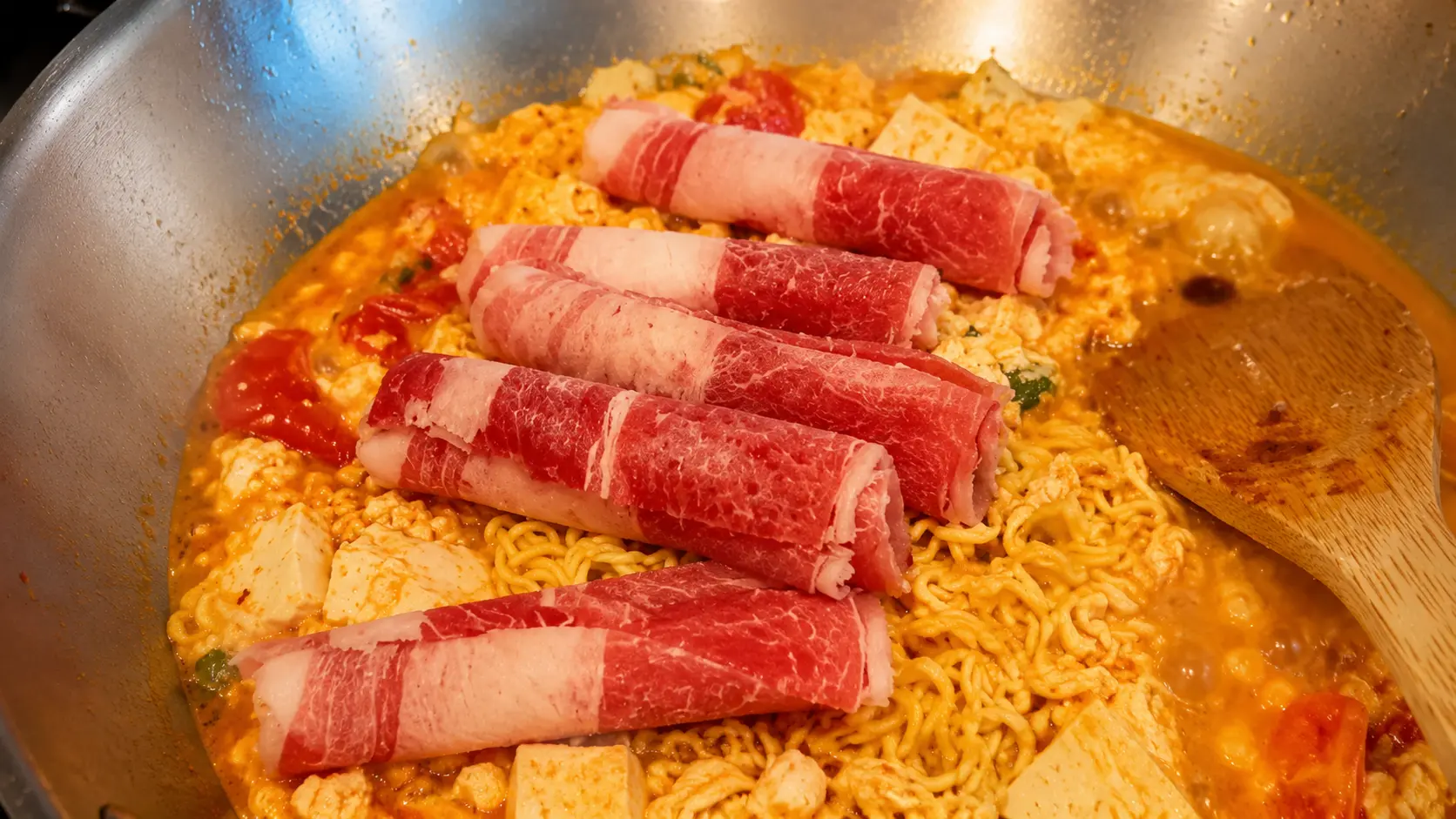 Thinly sliced pork added to cheesy Shin ramen noodles with tofu in a creamy spicy broth.