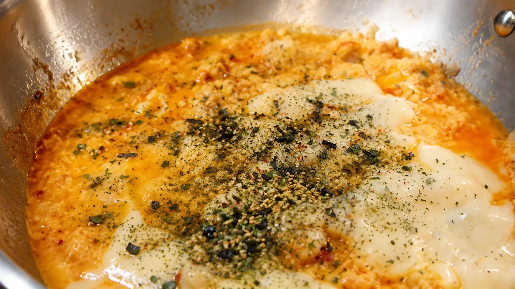 Creamy cheesy Shin ramen noodles topped with savory furikake seasoning, melted white American cheese, and rich spicy broth in a skillet.