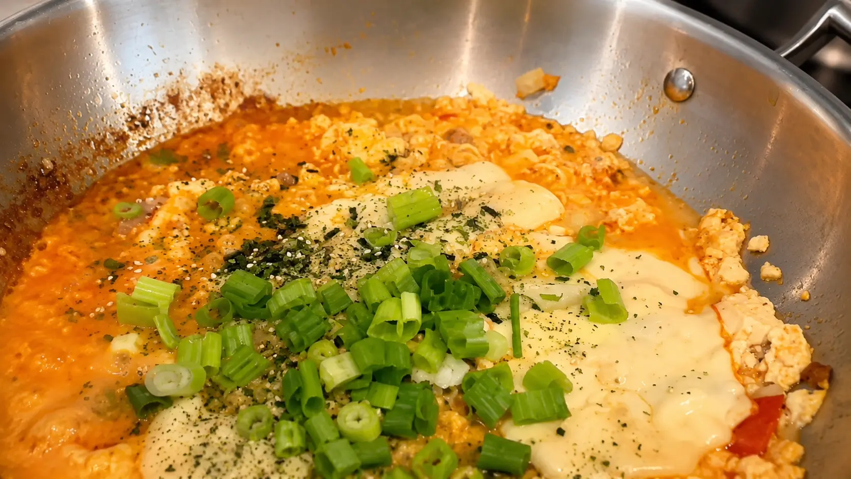 Creamy cheesy Shin ramen noodles topped with melted white American cheese, fresh green onions, and furikake in a rich spicy broth.