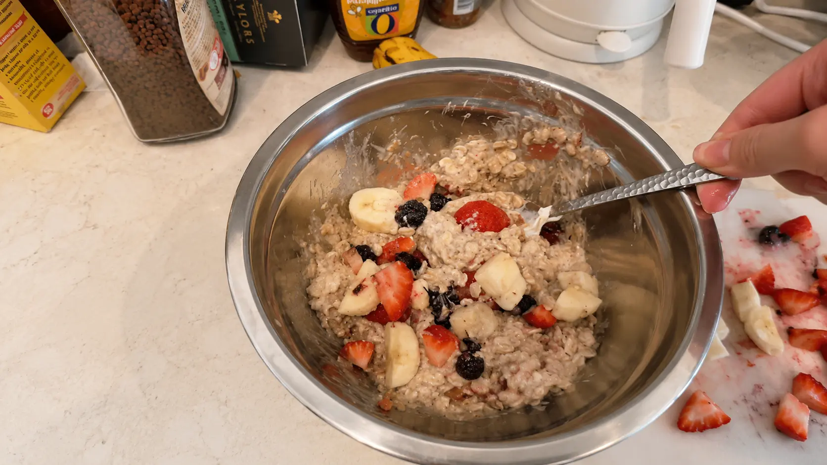 Creamy protein oatmeal mixed with fresh strawberries, blackberries, and bananas in a bowl, creating a healthy and colorful breakfast.
