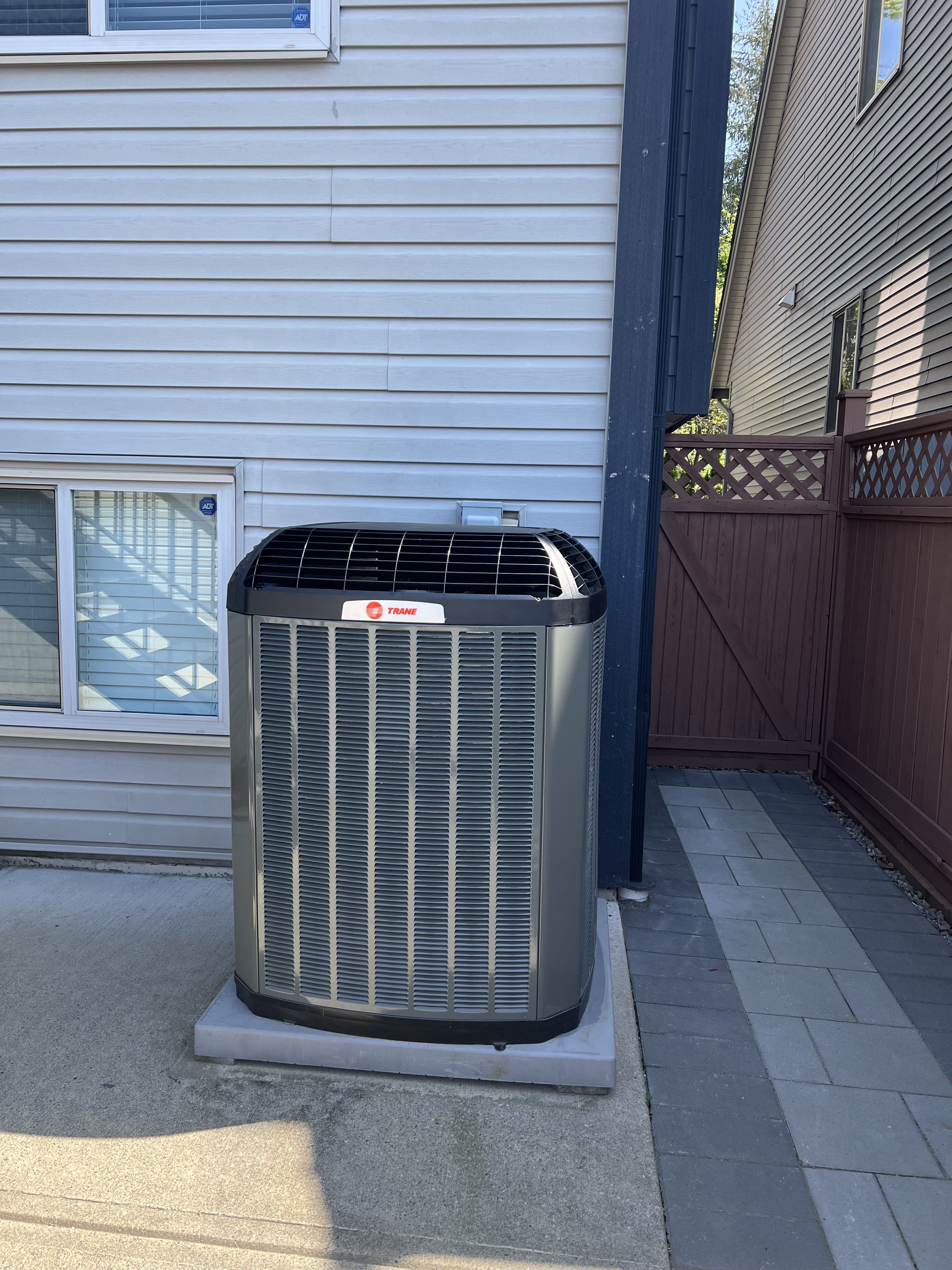 HVAC technician diagnosing a heat pump system for repair