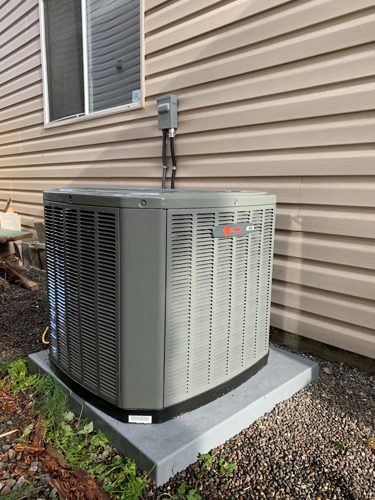 New high-efficiency air conditioner replacing an older outdoor unit