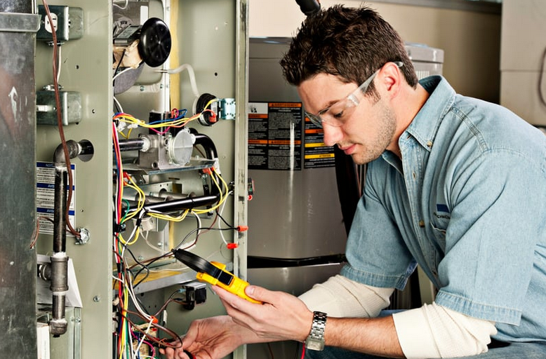 Emergency furnace repair being performed on a residential heating system