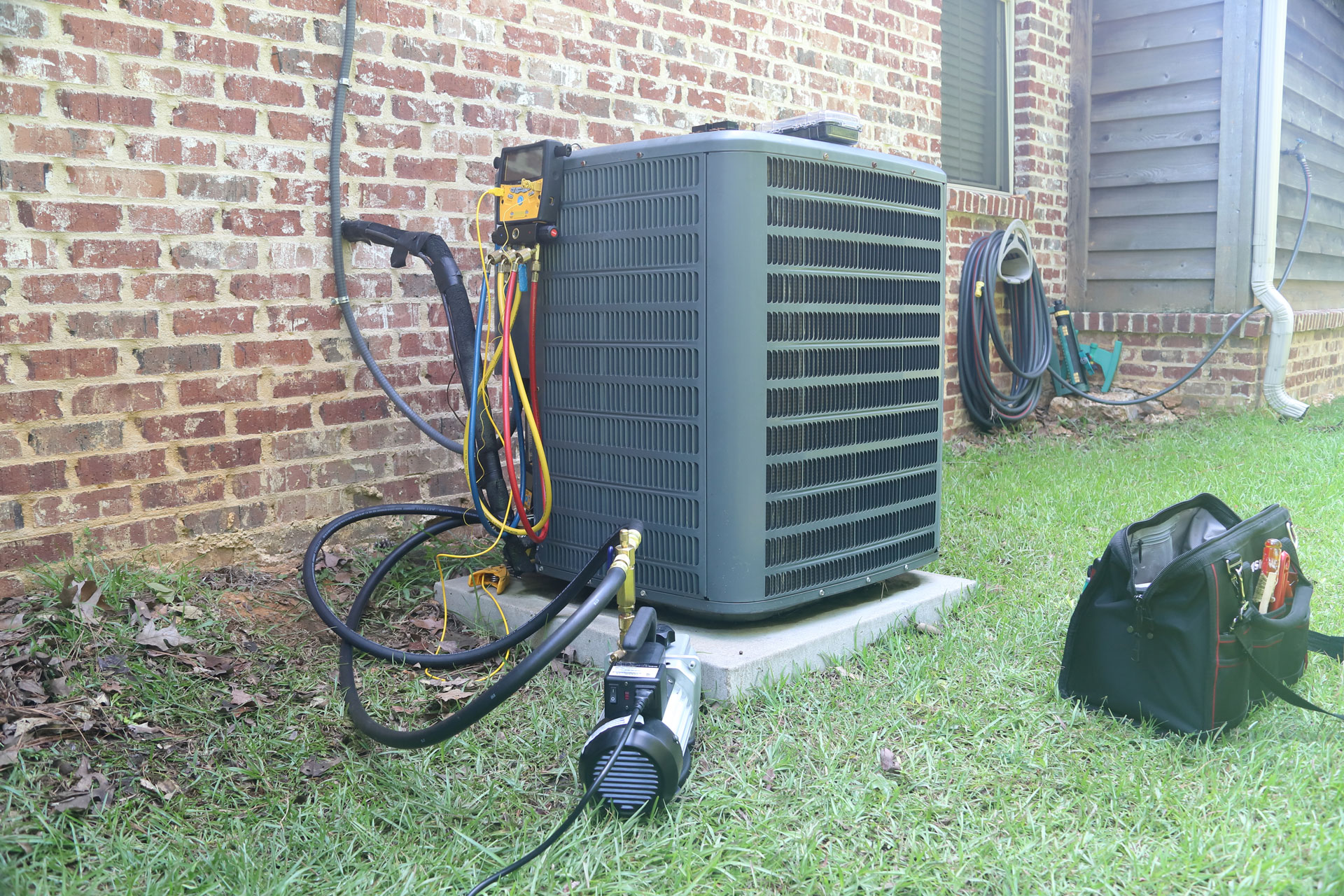 HVAC technician performing air conditioner repair and diagnostics