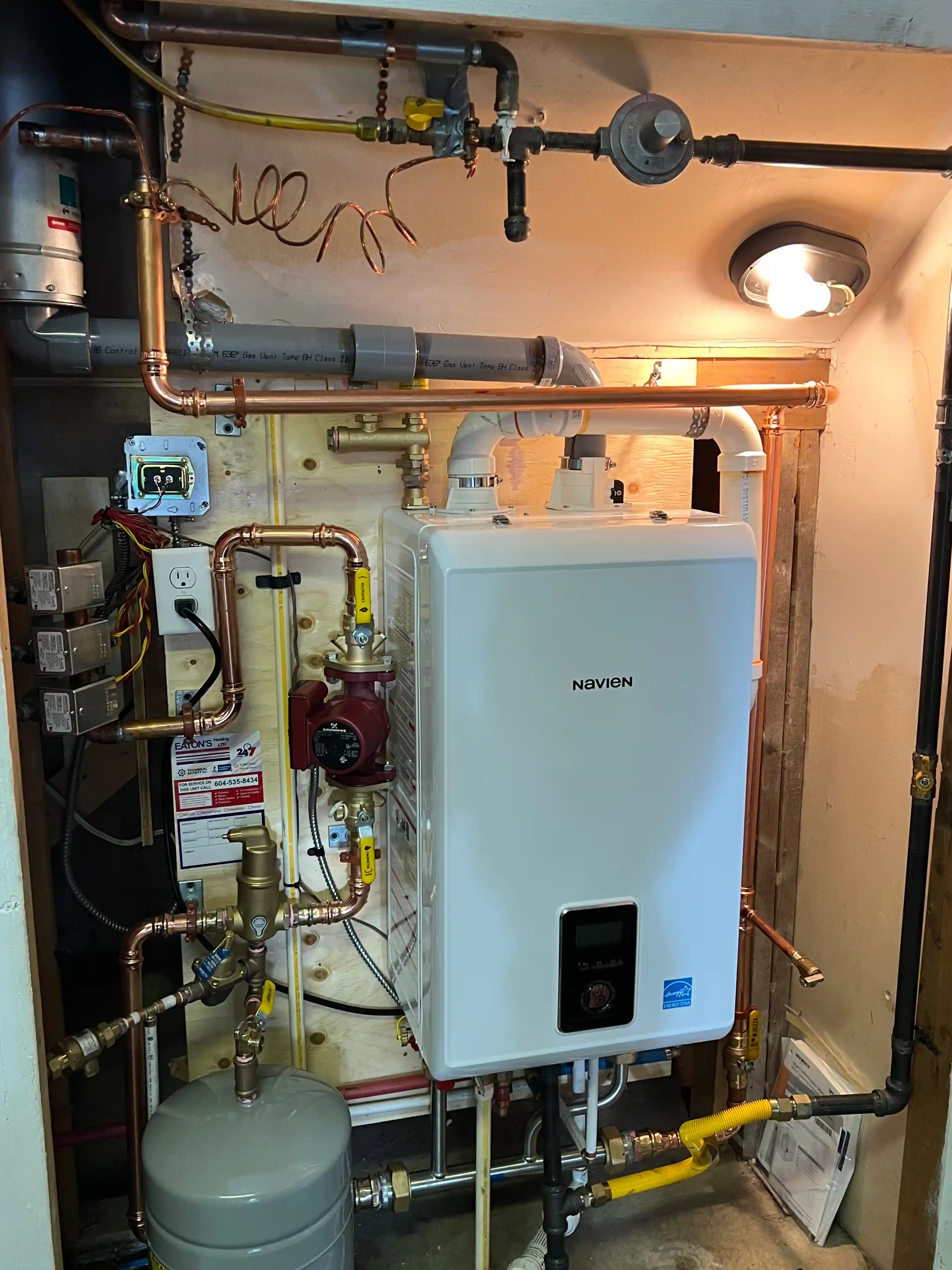 Boiler repair technician servicing a hydronic heating system in Burnaby