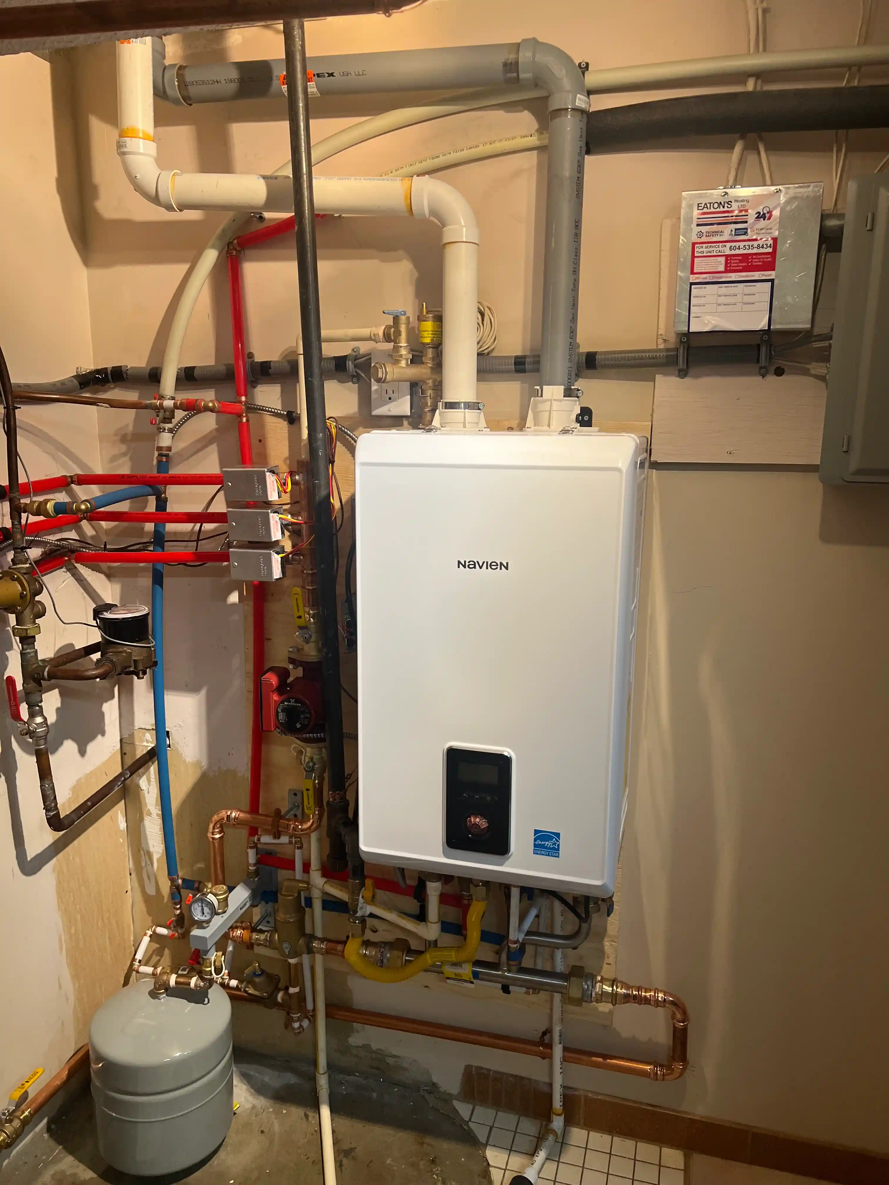 New condensing boiler installation with piping manifold and isolation valves in Burnaby