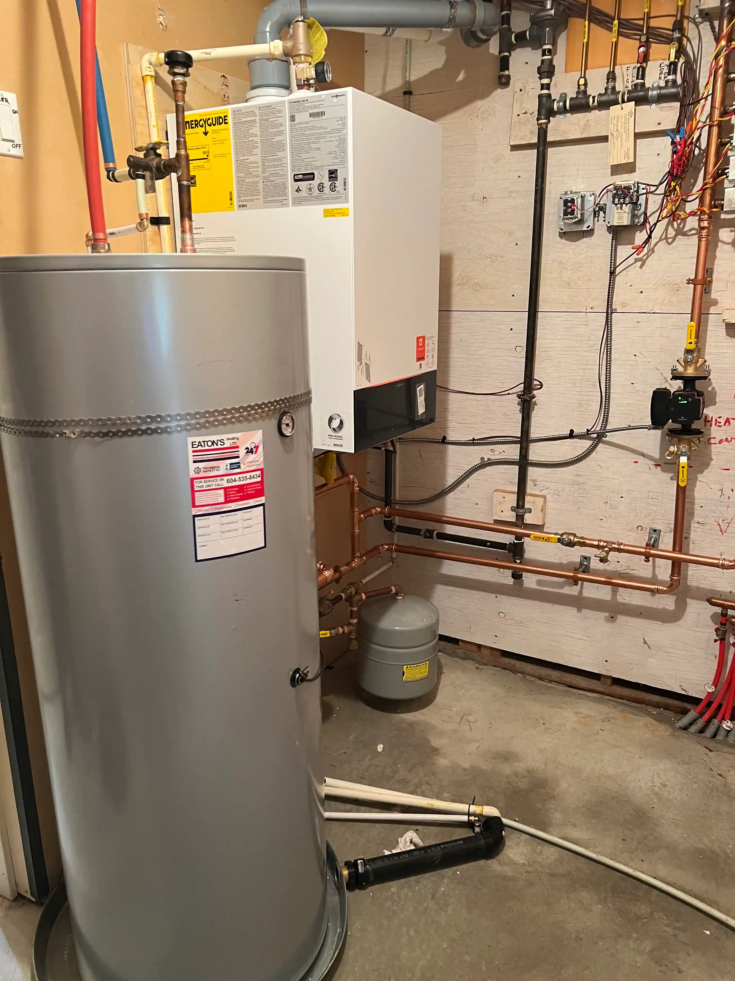 Wall-mounted condensing boiler with venting and gas connections during installation