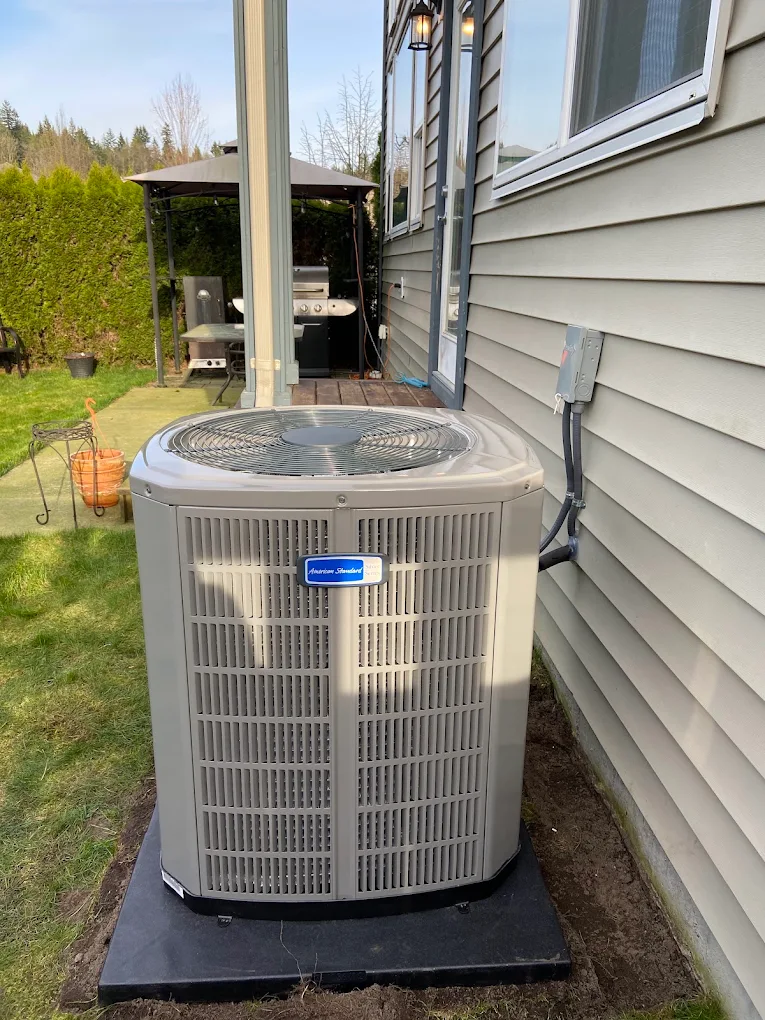 Air conditioner condenser unit being repaired during a service call in Burnaby