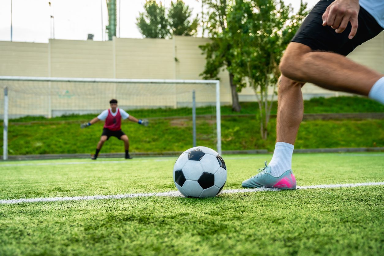 Soccer player taking a shot on goal — sports injuries treated with prolozone injections