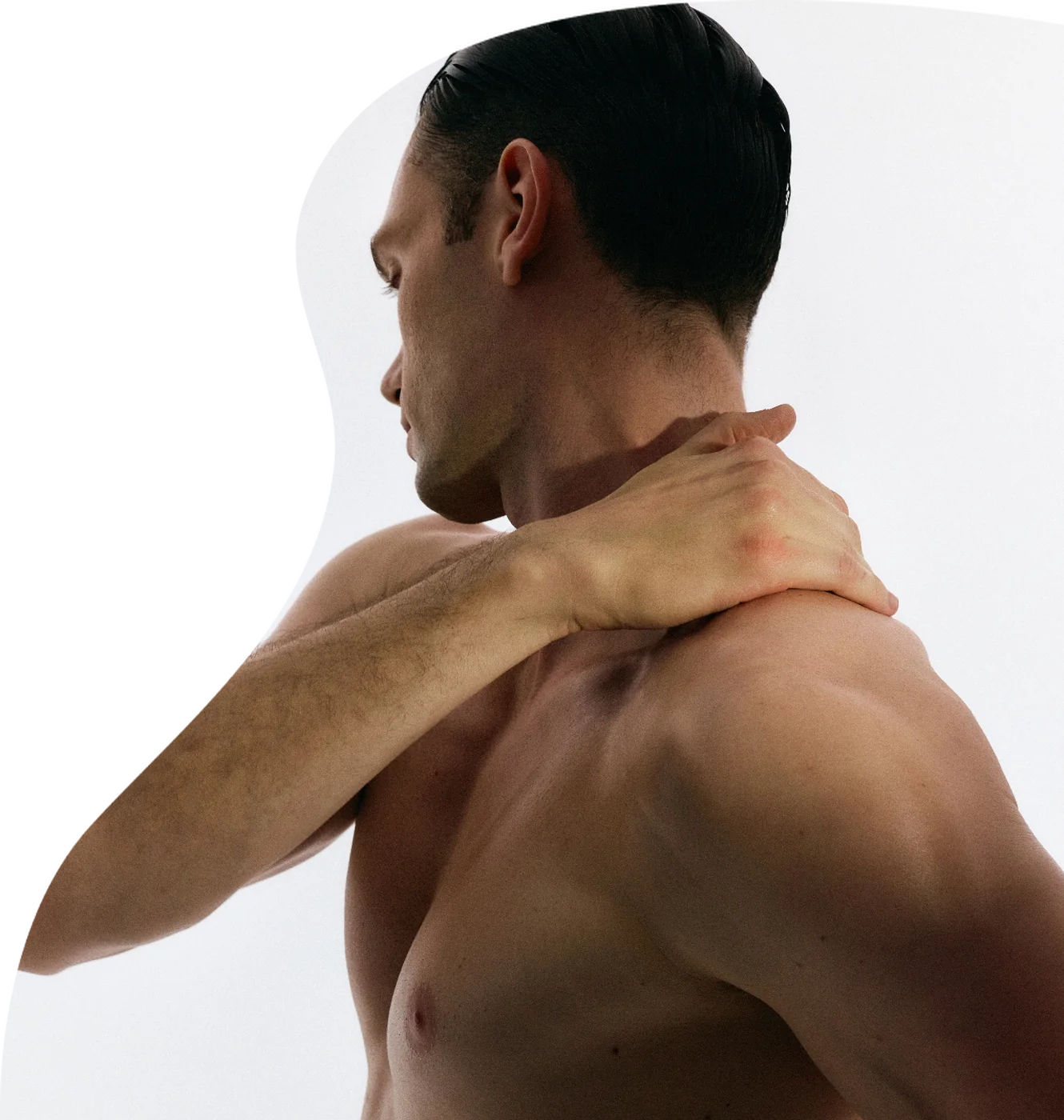 Man rubbing a sore neck and shoulder — chronic pain treated with prolotherapy in Toronto