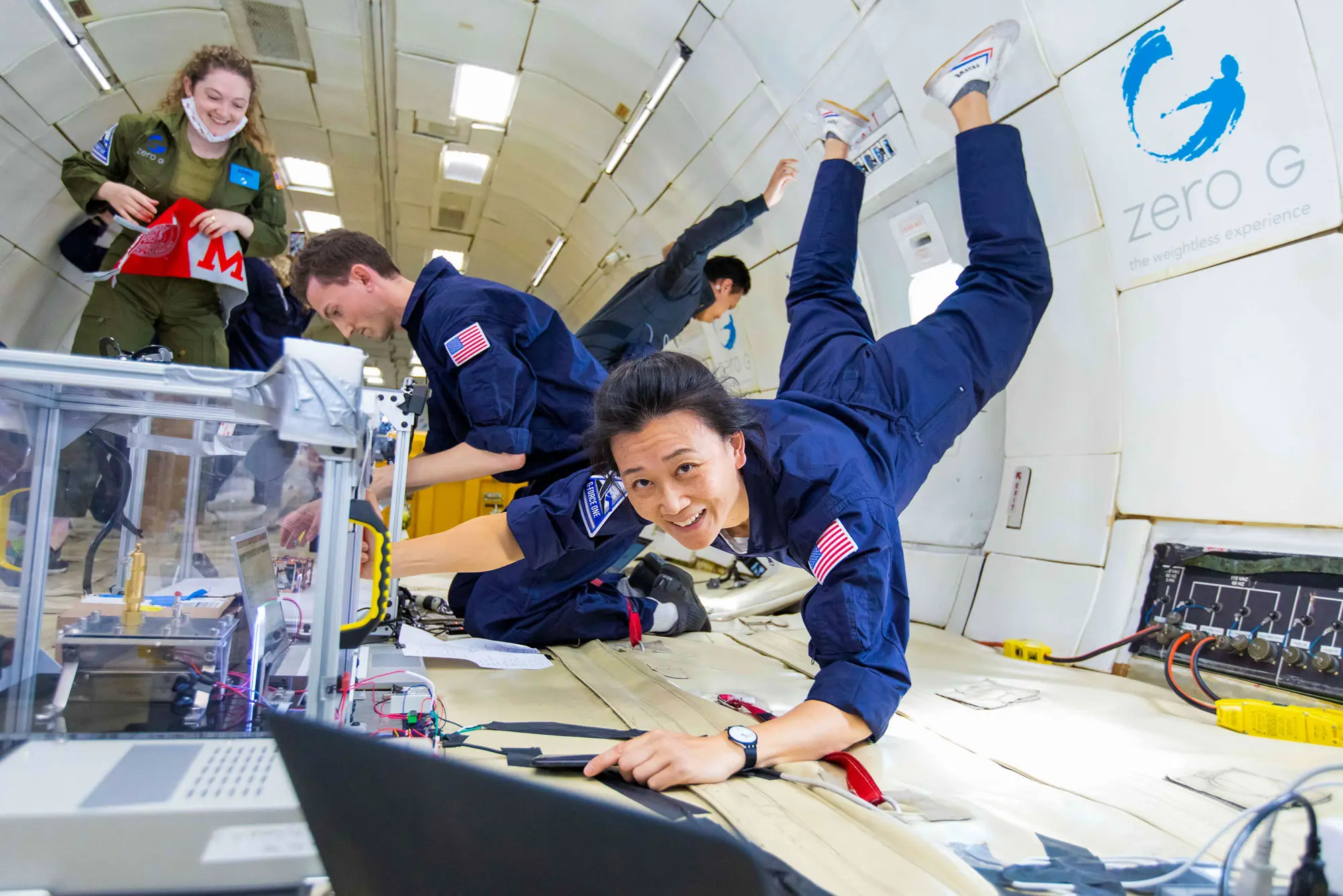 Researchers conduct scientific experiments in a zero gravity environment aboard a Zero-G flight, experiencing weightlessness firsthand.
