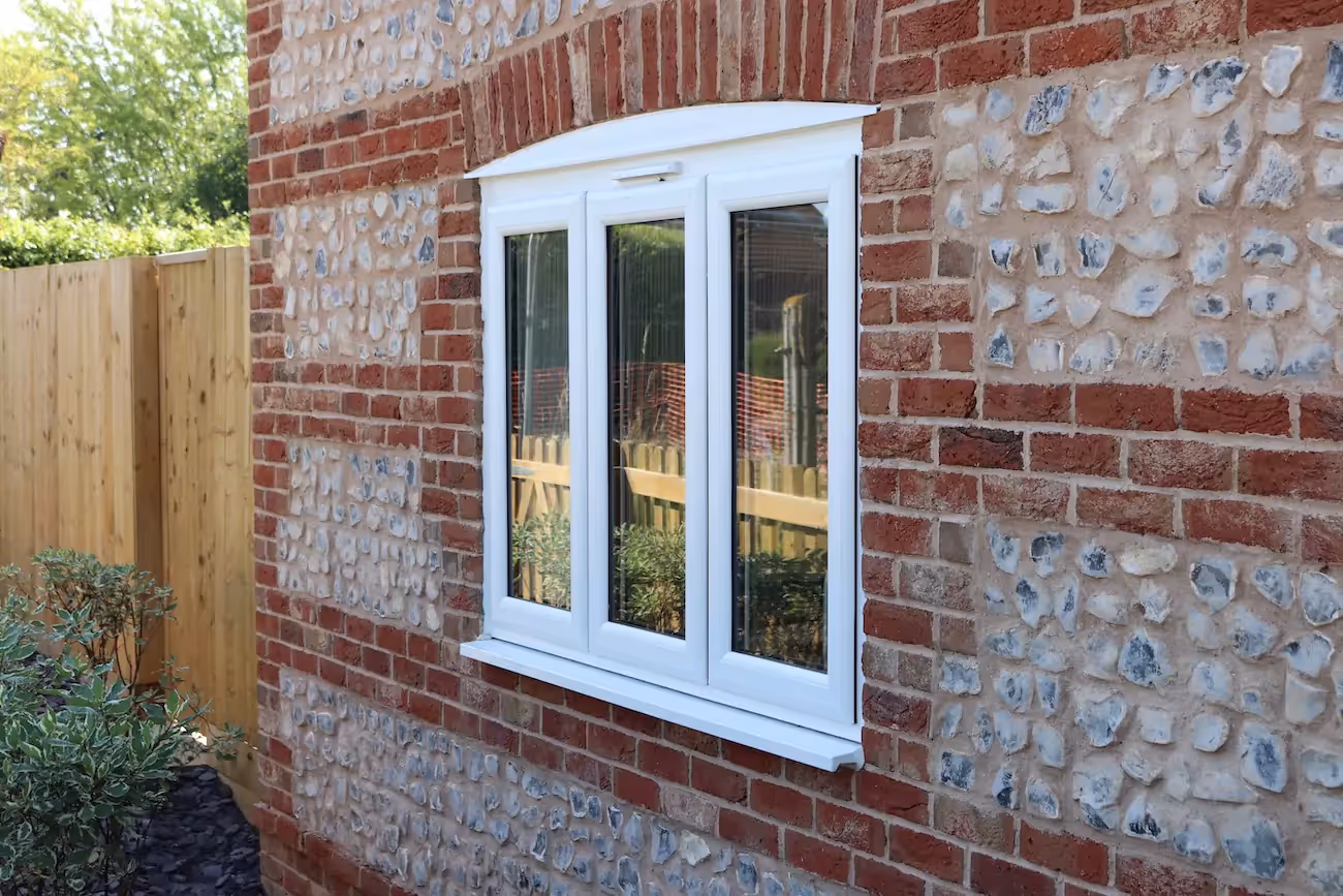 Casement windows on a brick cottage taken from the garden