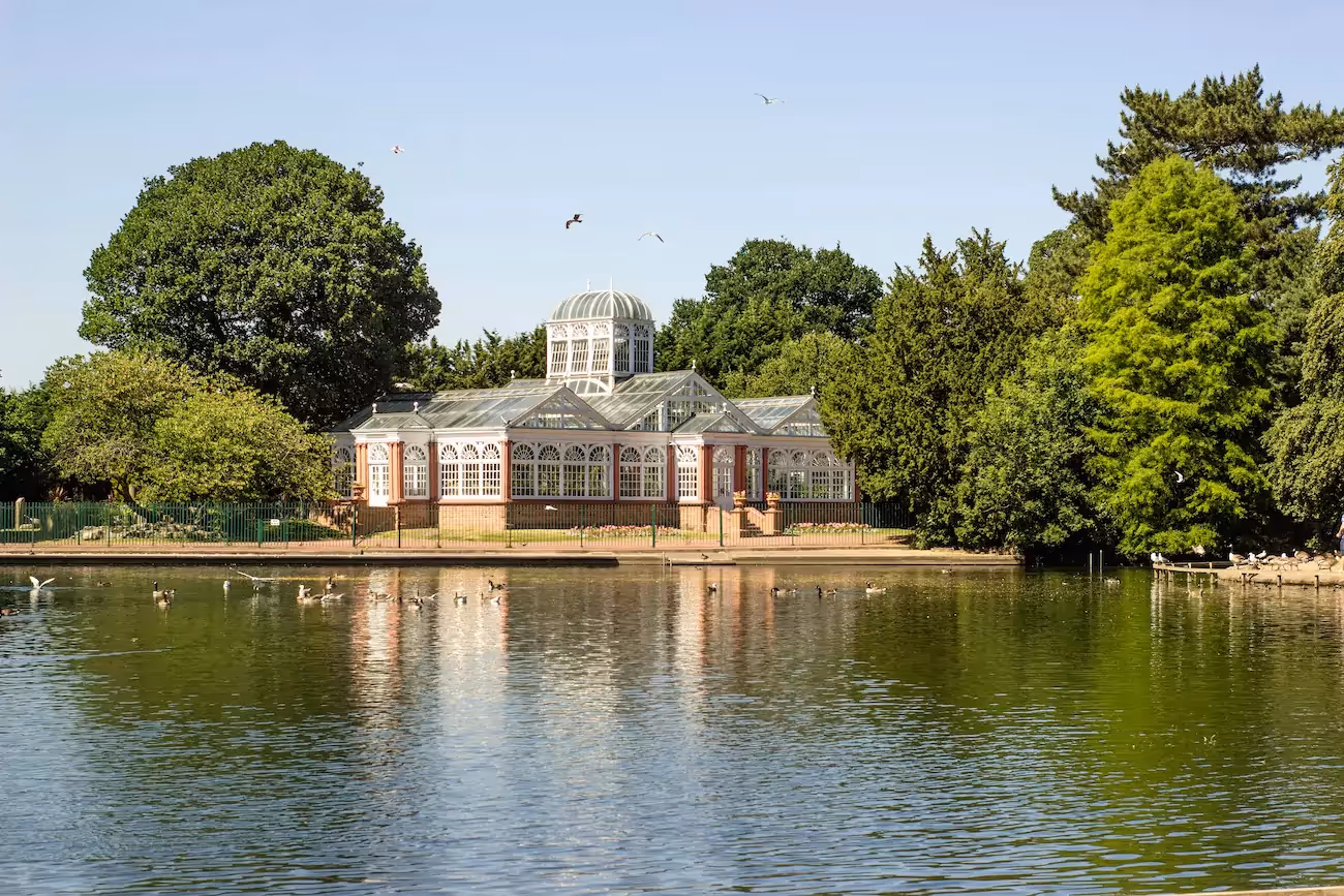 View of a stately style home from a river on a summers day