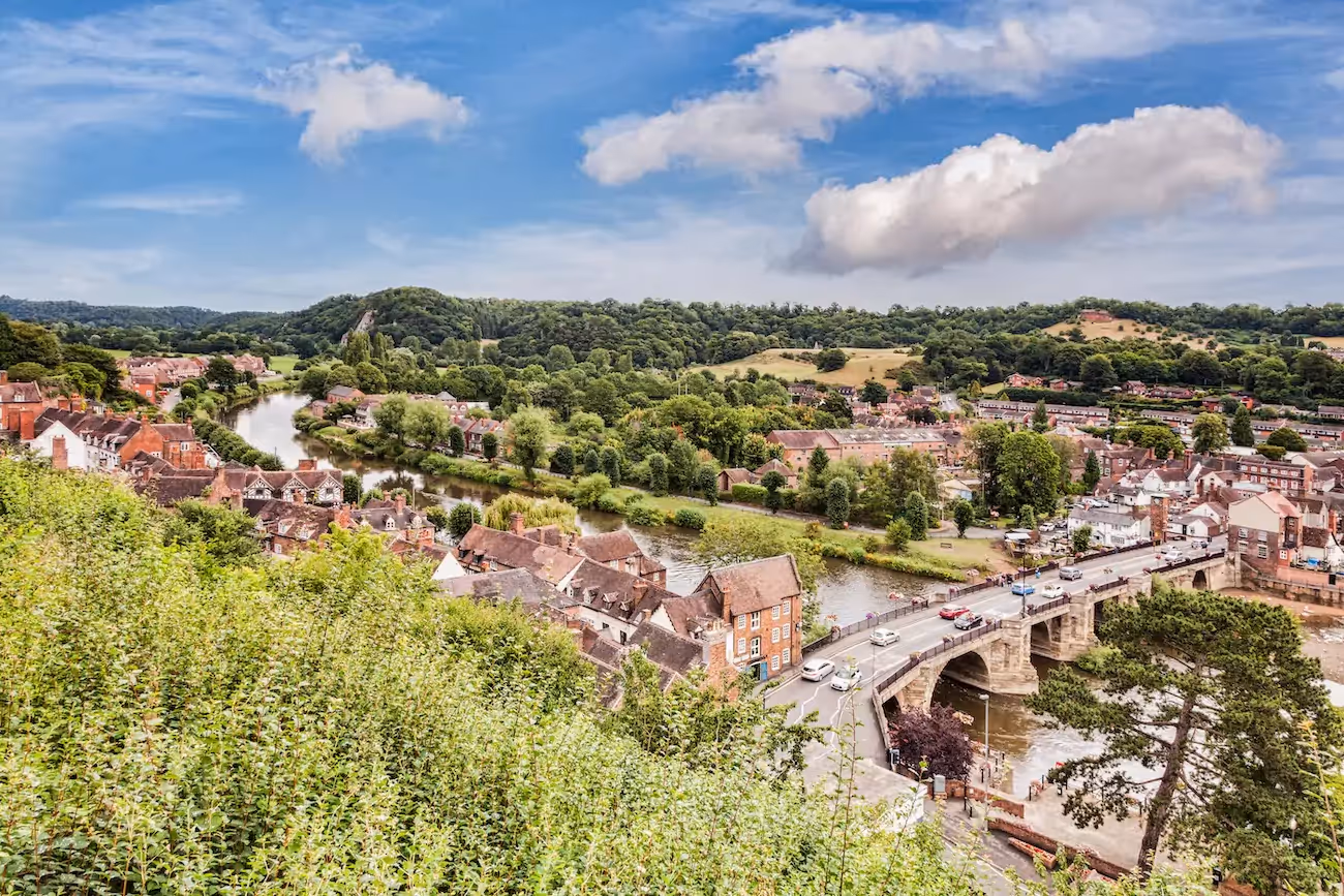 view of Bridgenorth from a grassy hill on a sunny day