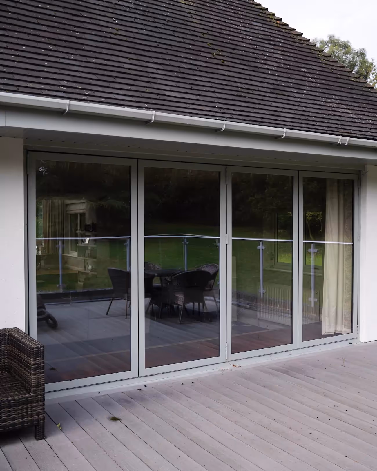 Sliding door windows on a modern home on a grey patio
