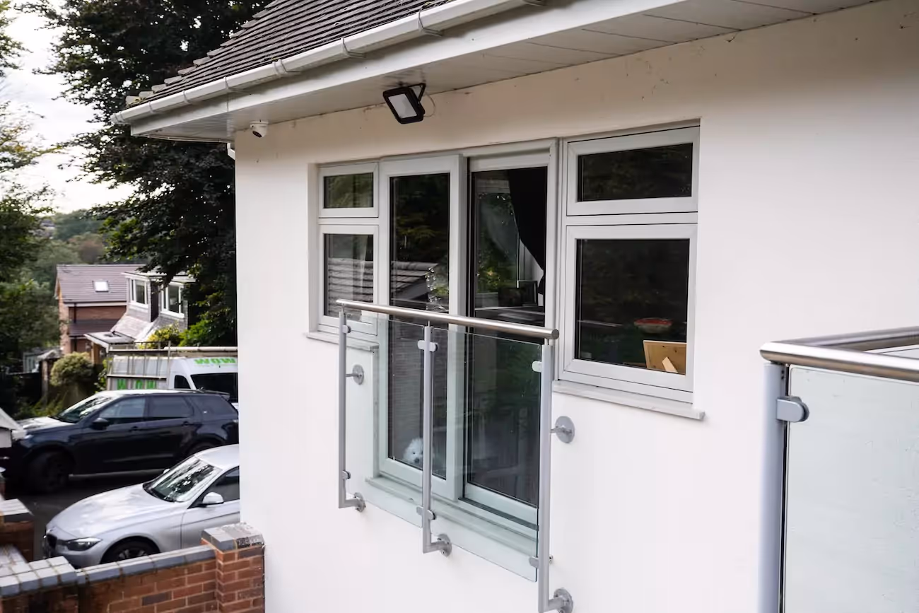 Newly fitted windows with balcony on a white modern home