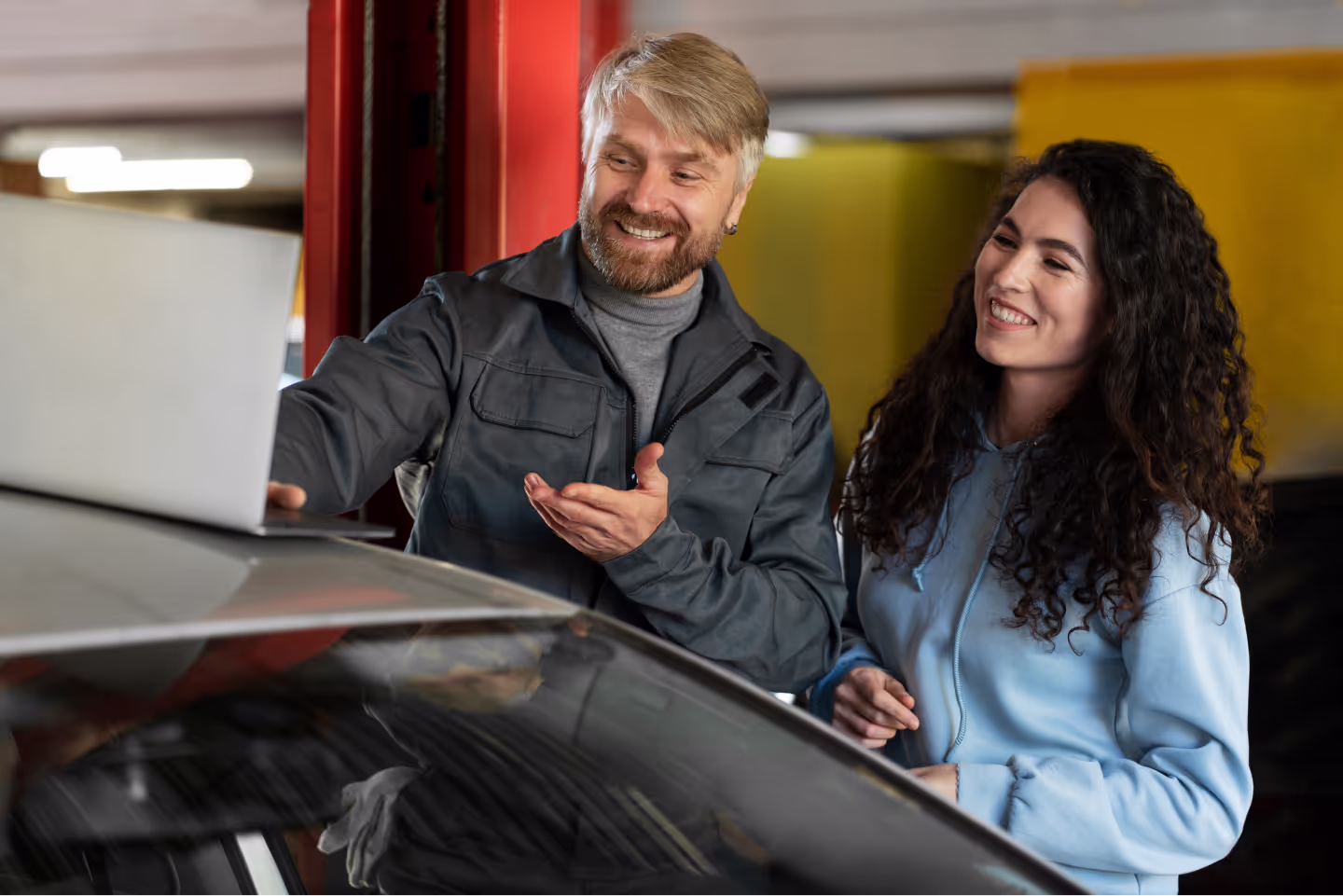 Happy RHD Tire employee with a smiling customer