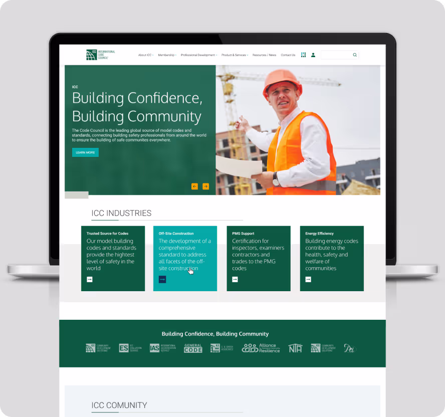 Laptop revealing ICC Industries website with headline ‘Building Confidence, Building Community,’ featuring a person in a hard hat and high-visibility vest holding blueprints on a construction site.