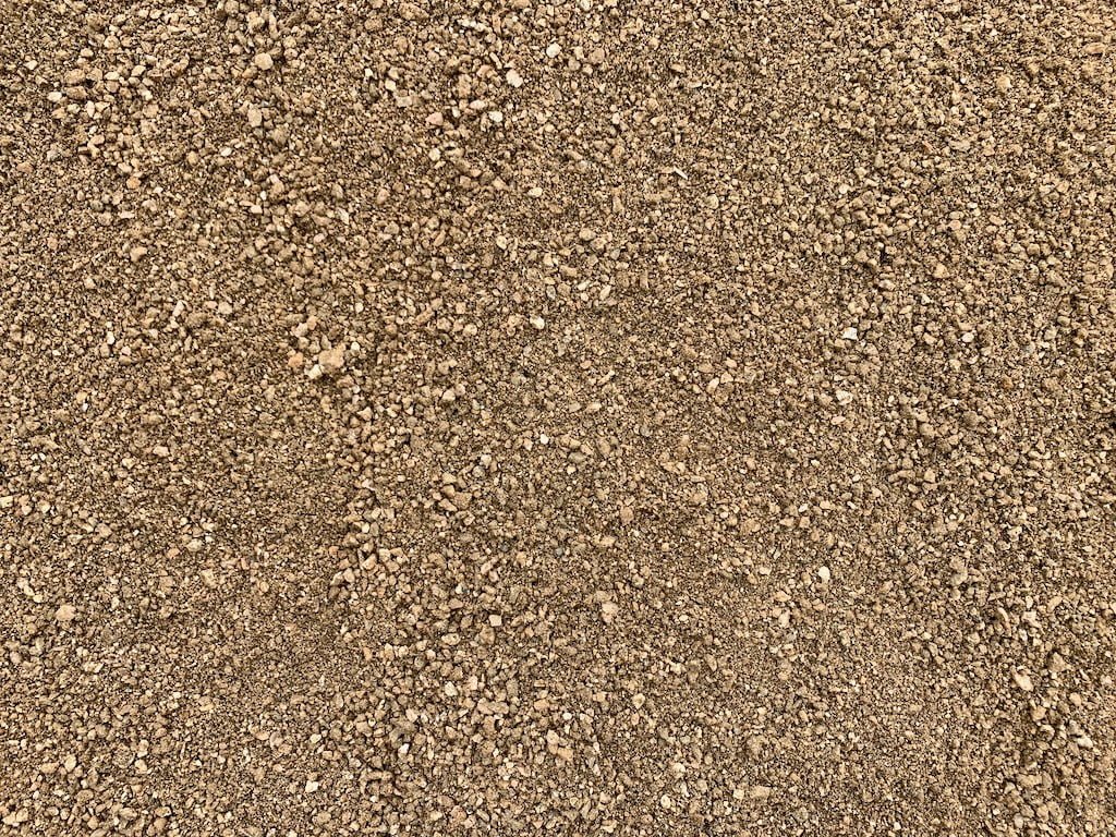 Decomposed granite, the material installed and compacted over base rock on sloped yards and putting greens