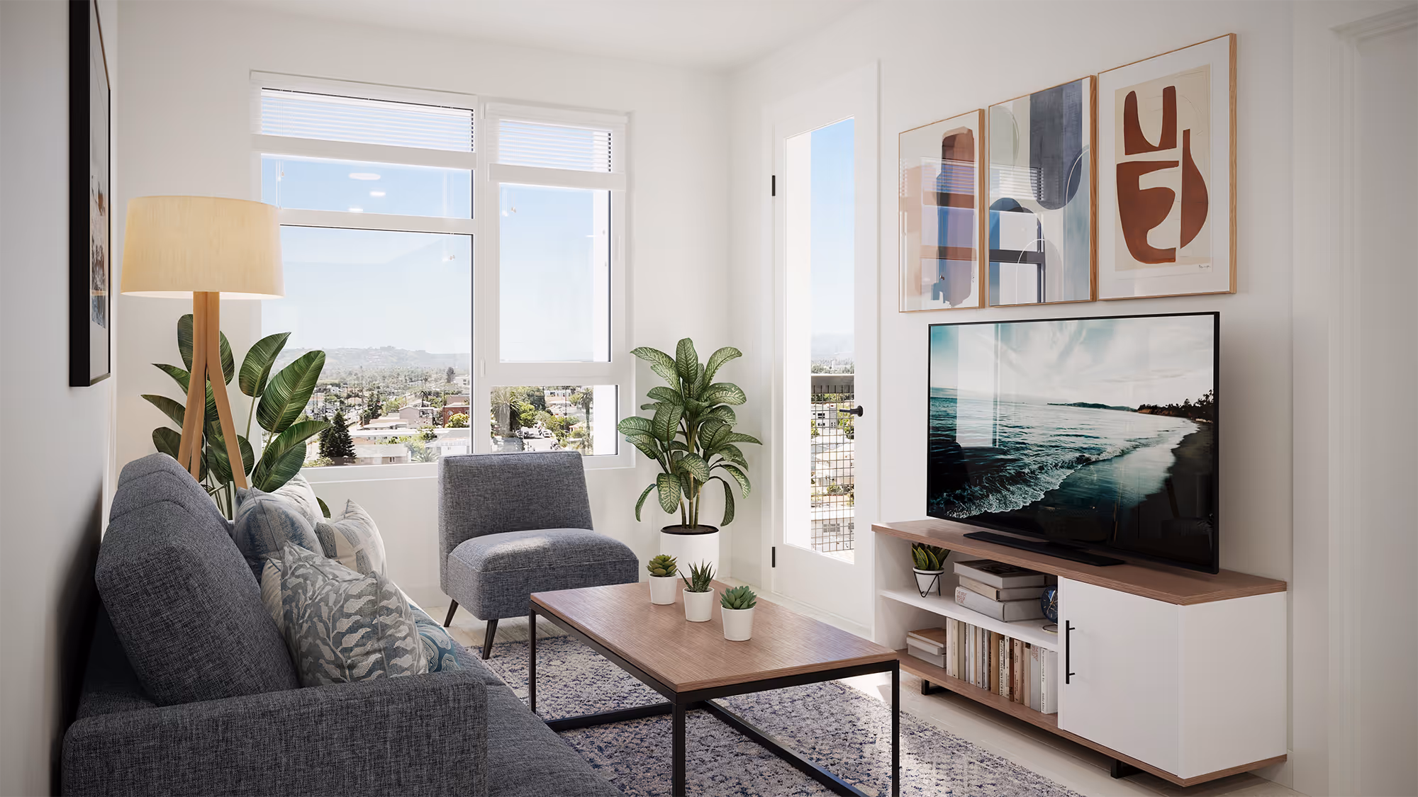 Bright apartment living room with a gray sofa, large windows, and a TV, showcasing the modern design at Tessera in Los Angeles, CA.