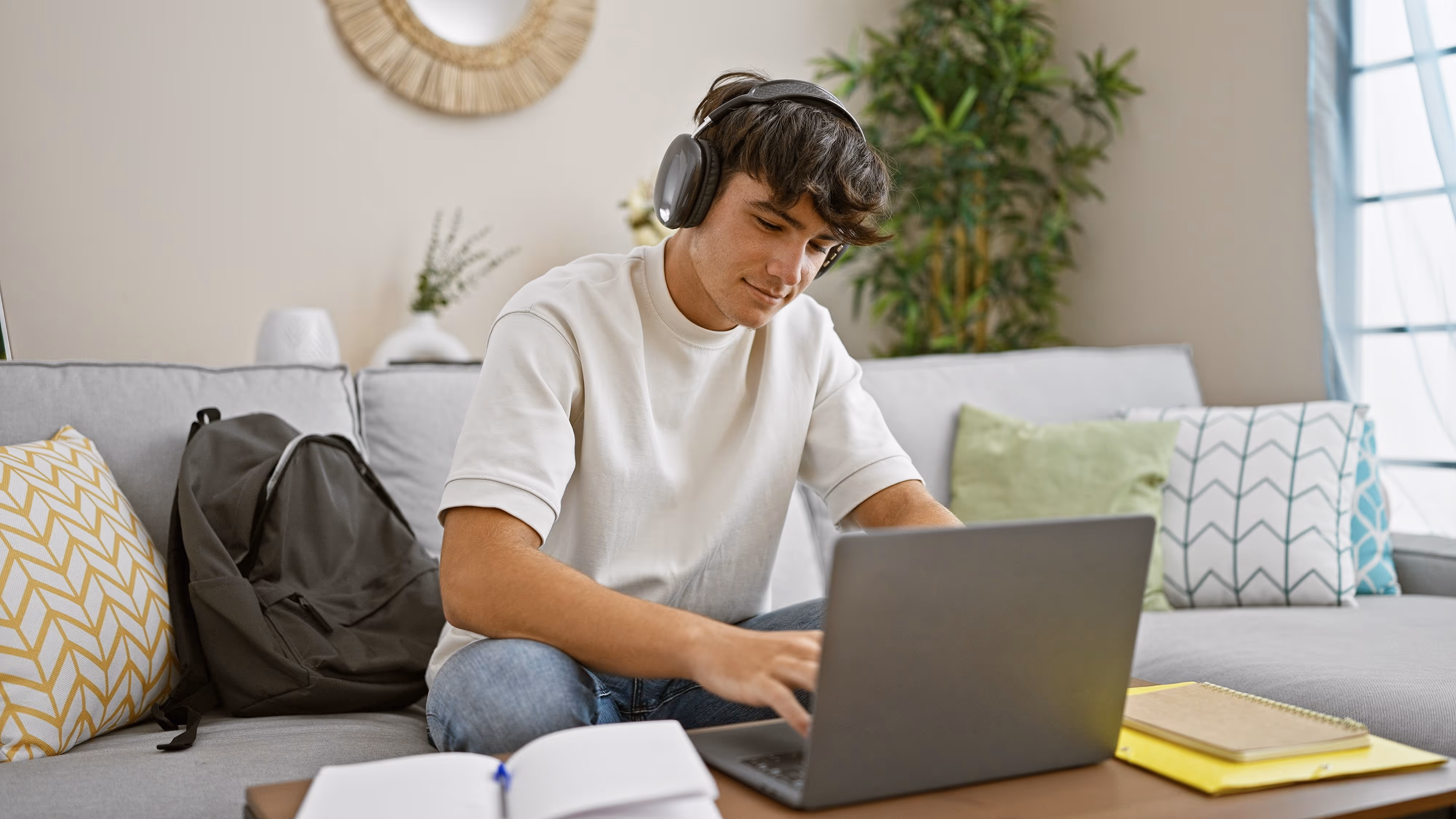 student in off-campus apartment living room in Los Angeles on computer