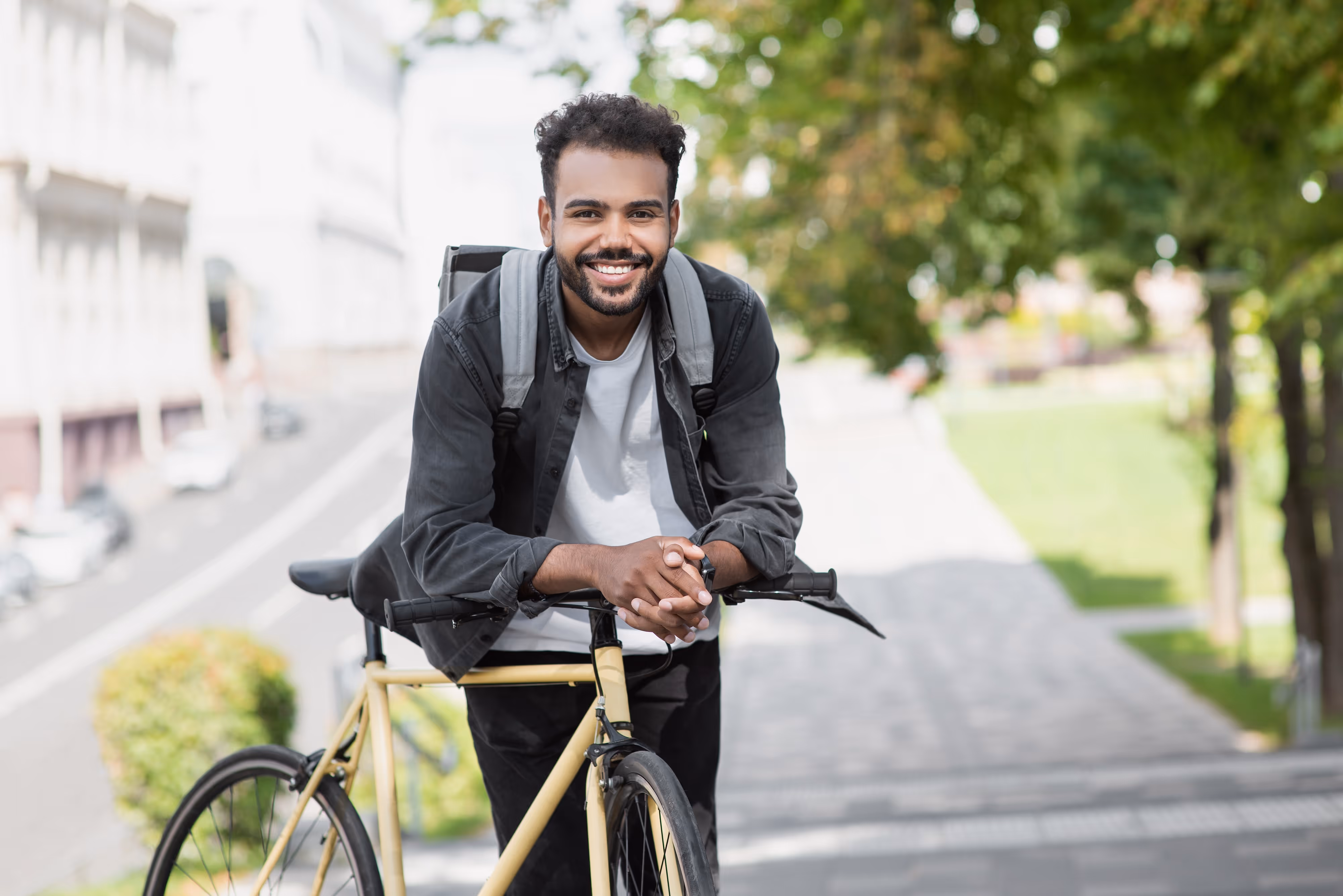 Student resident biking near Tessera apartments, enjoying convenient access to USC campus and commuting options