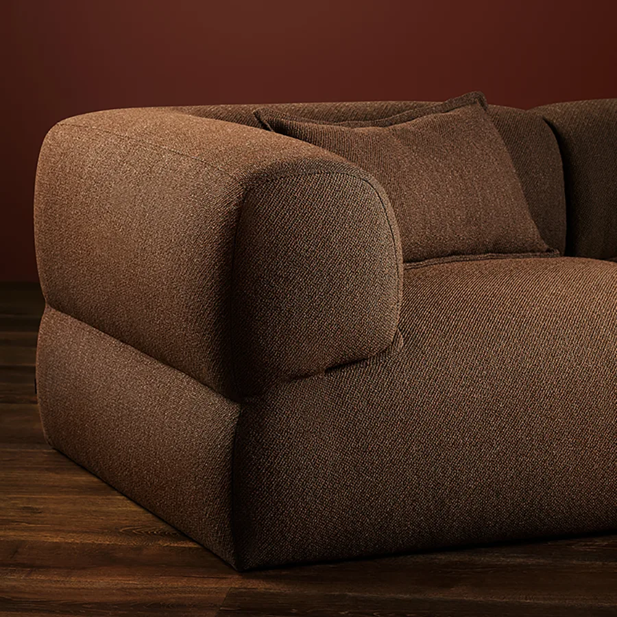 Didier Puffalo modern gray modular lounge chair with wide armrests and a single pink cushion.