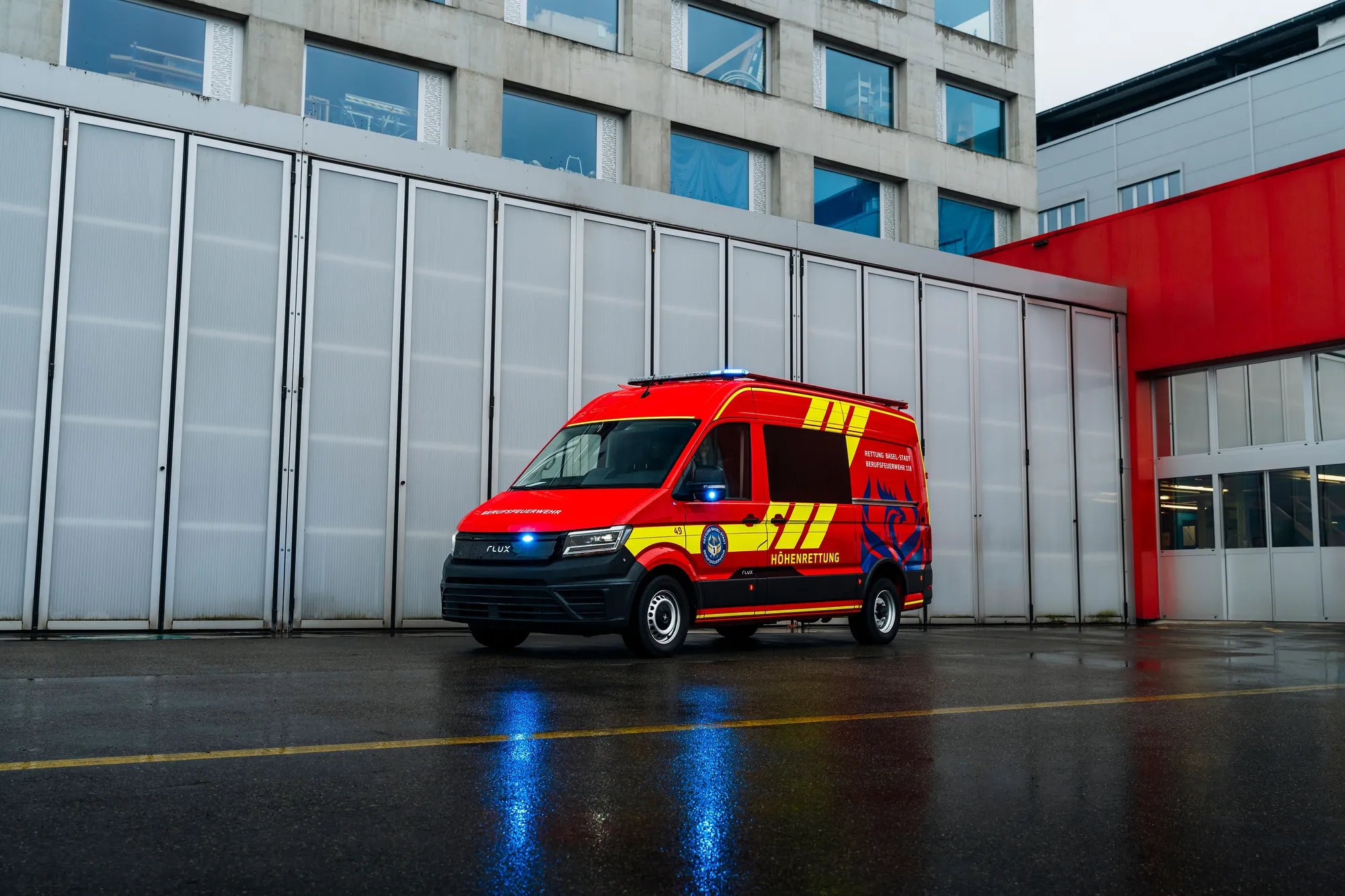 Elektrisches Feuerwehrfahrzeug auf Basis MAN TGE mit Kofferaufbau vor einer Fahrzeughalle