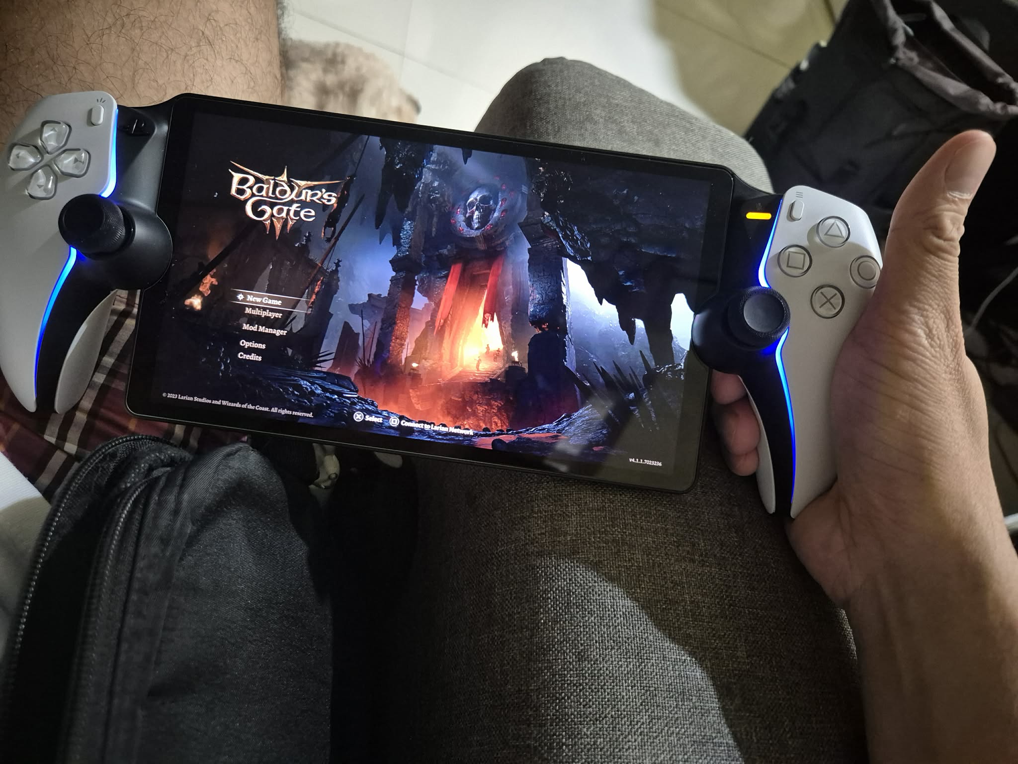 A photo of me holding my PlayStation Portal while playing Baldur's Gate 3 in it.