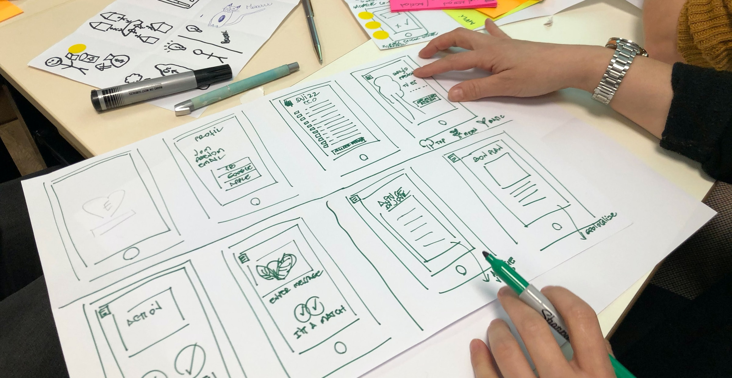 Image showing someone drawing  mobile wireframe or interface.