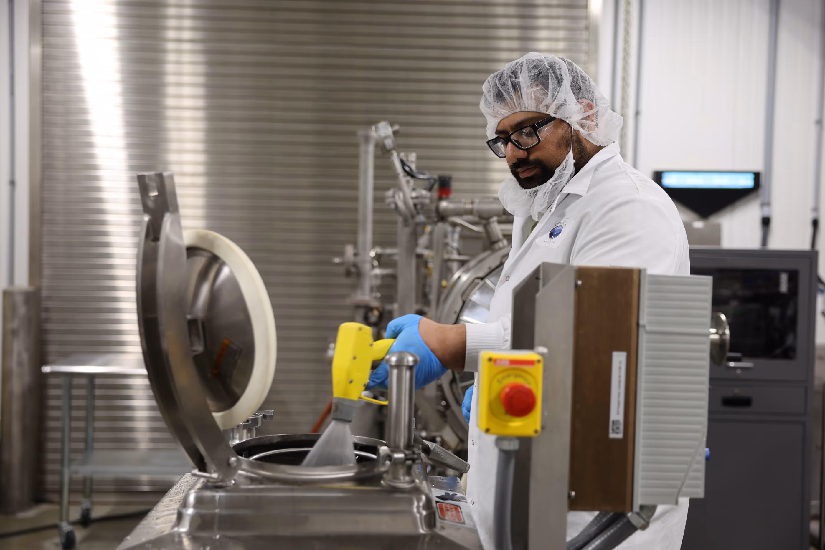 R&D scientist putting water into a machine.
