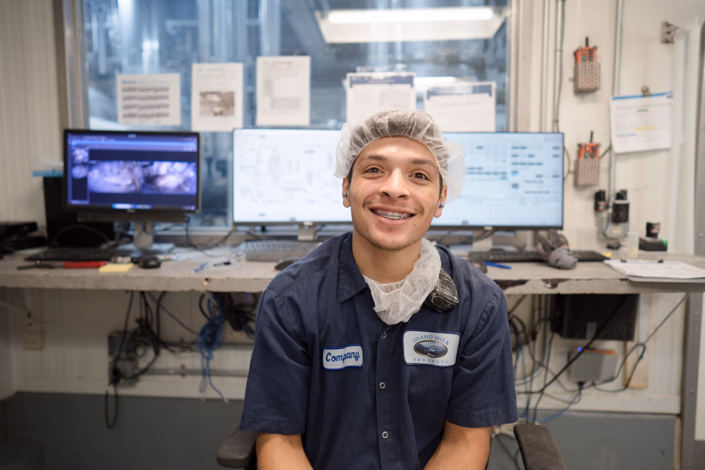 A plant employee in his work environment smiling