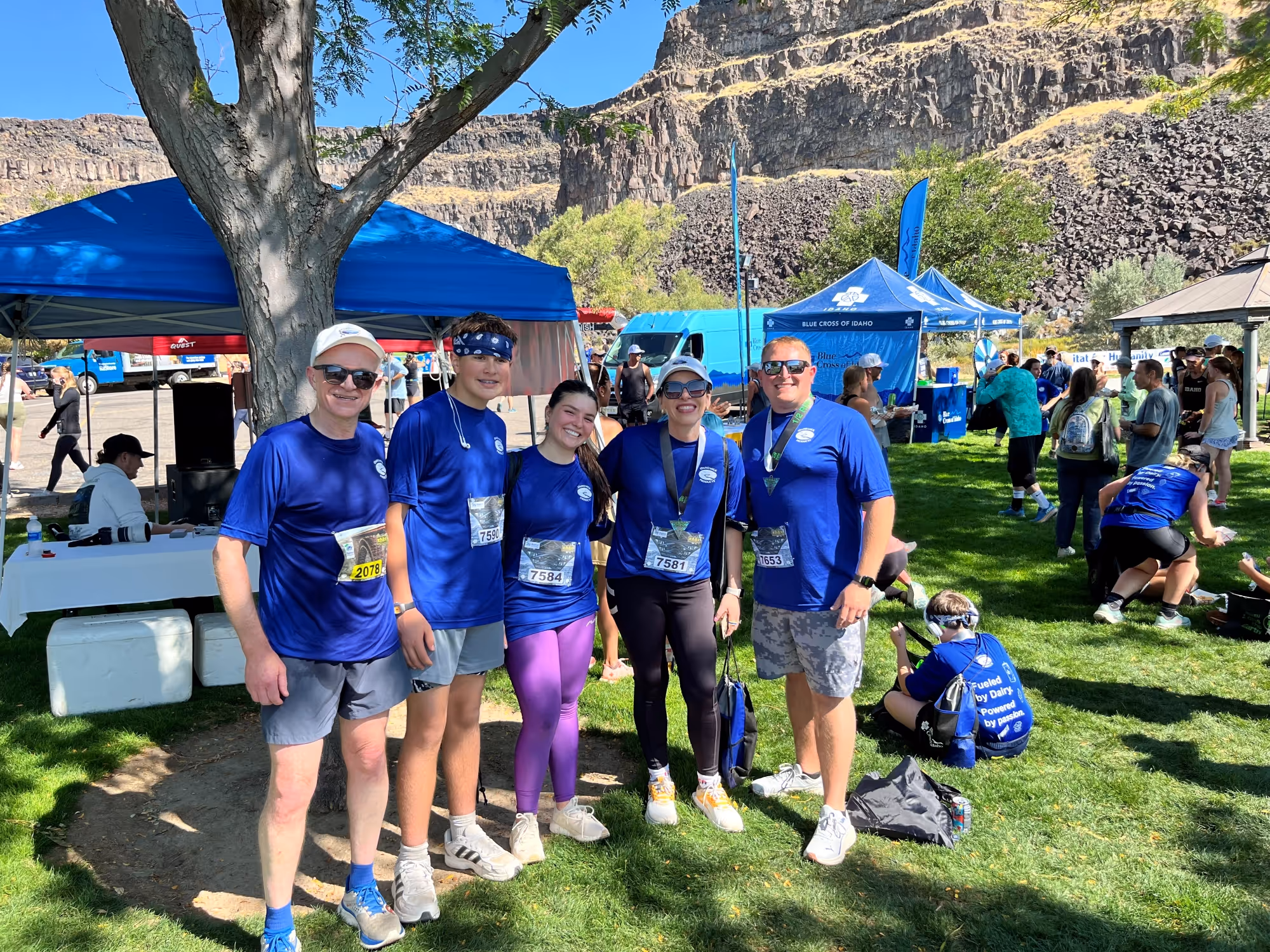 A group of employees and family members posing for a photo during an event.