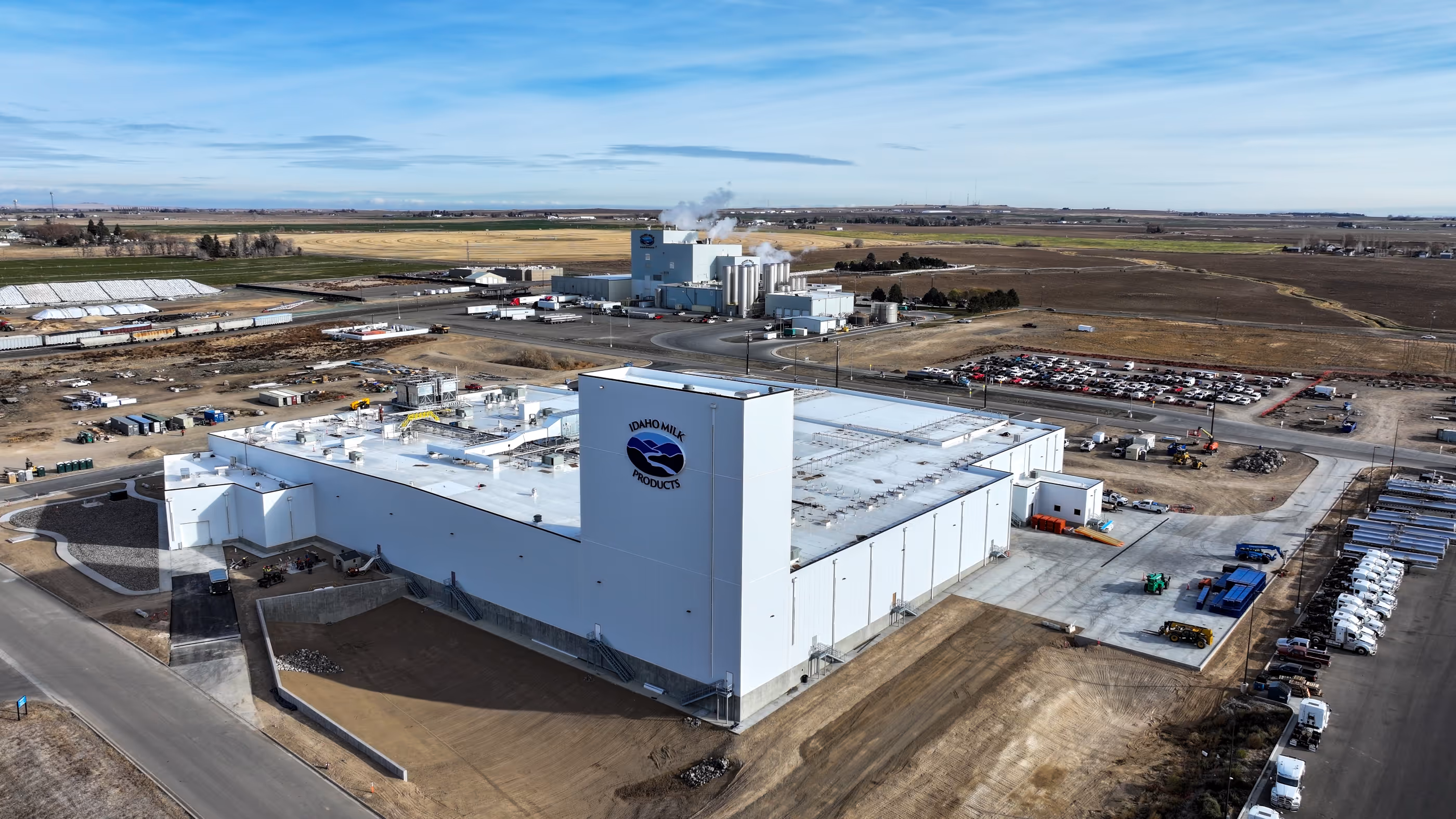 Picture of our ice cream plant with new sign with old plant in the background