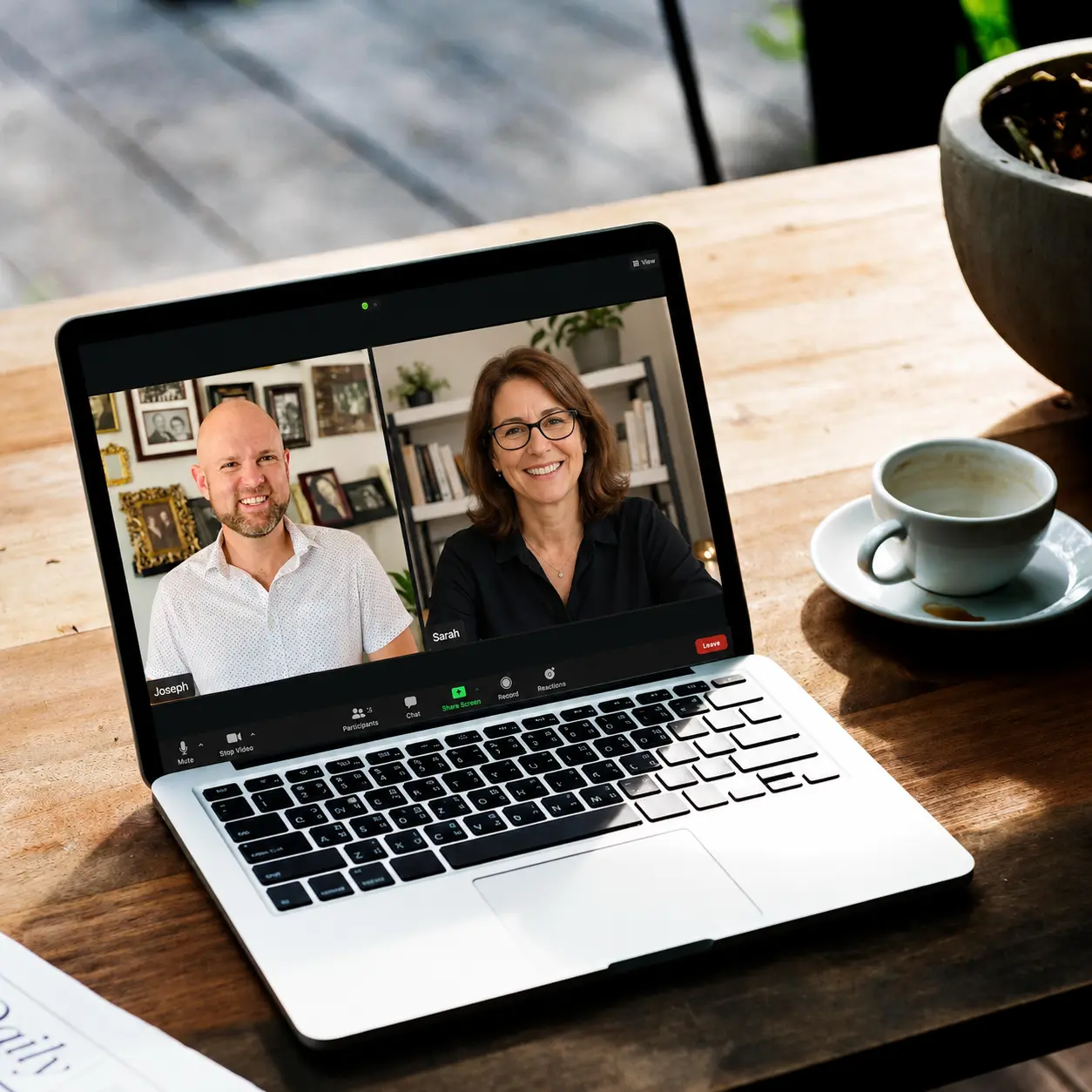 Laptop showing a virtual consultation meeting between two individuals.