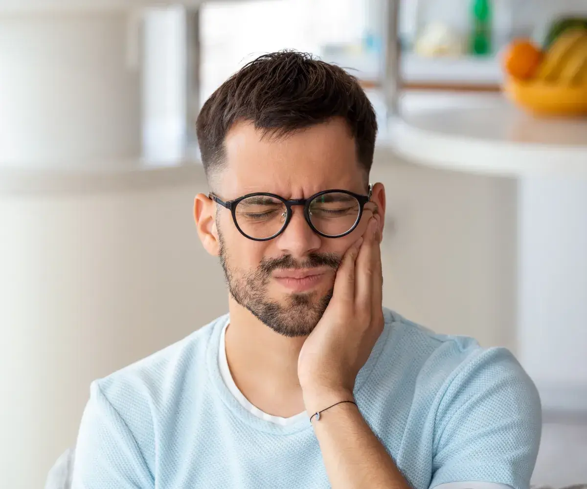 A man with glasses is looking at something.