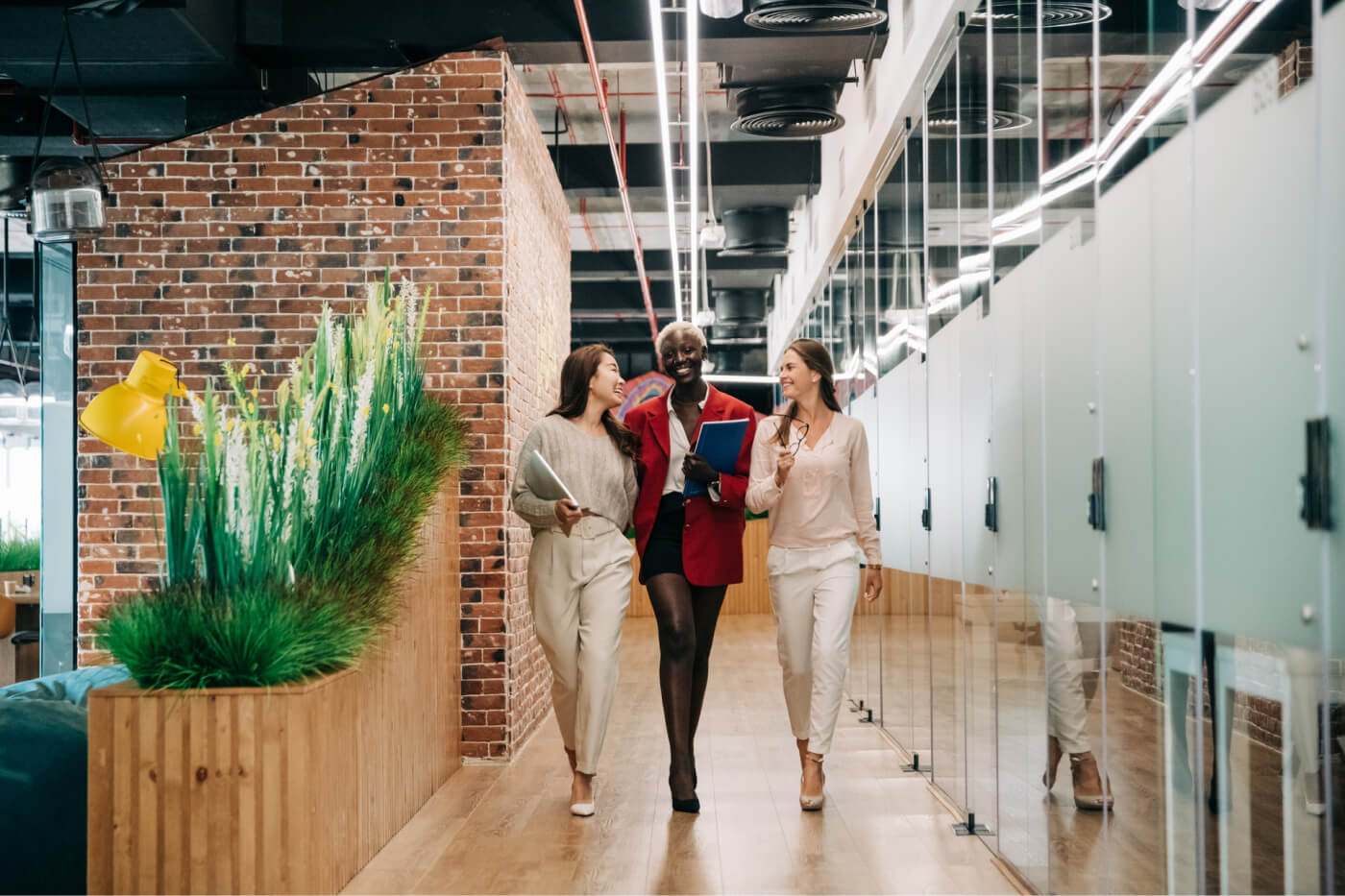 A group od people walking and talking in a hallway