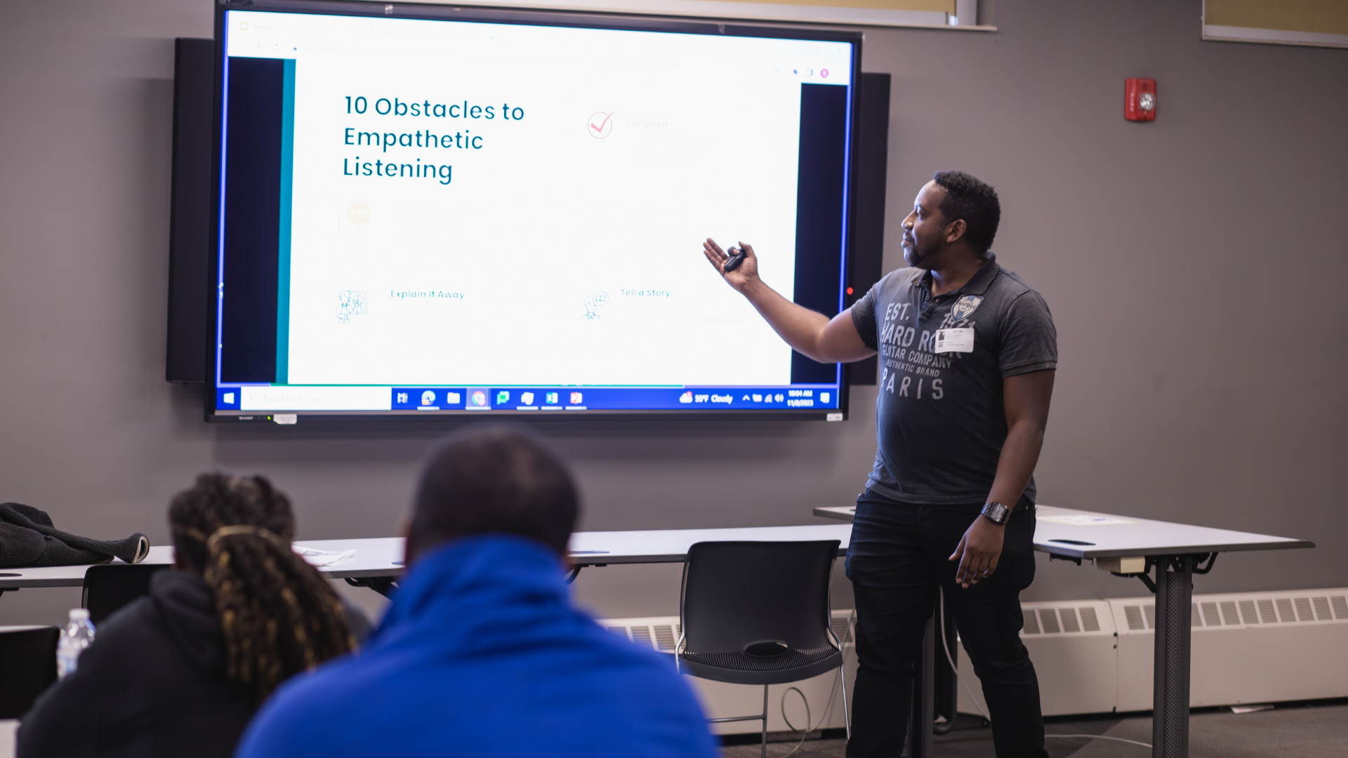 A man giving a presentation on a large screen.