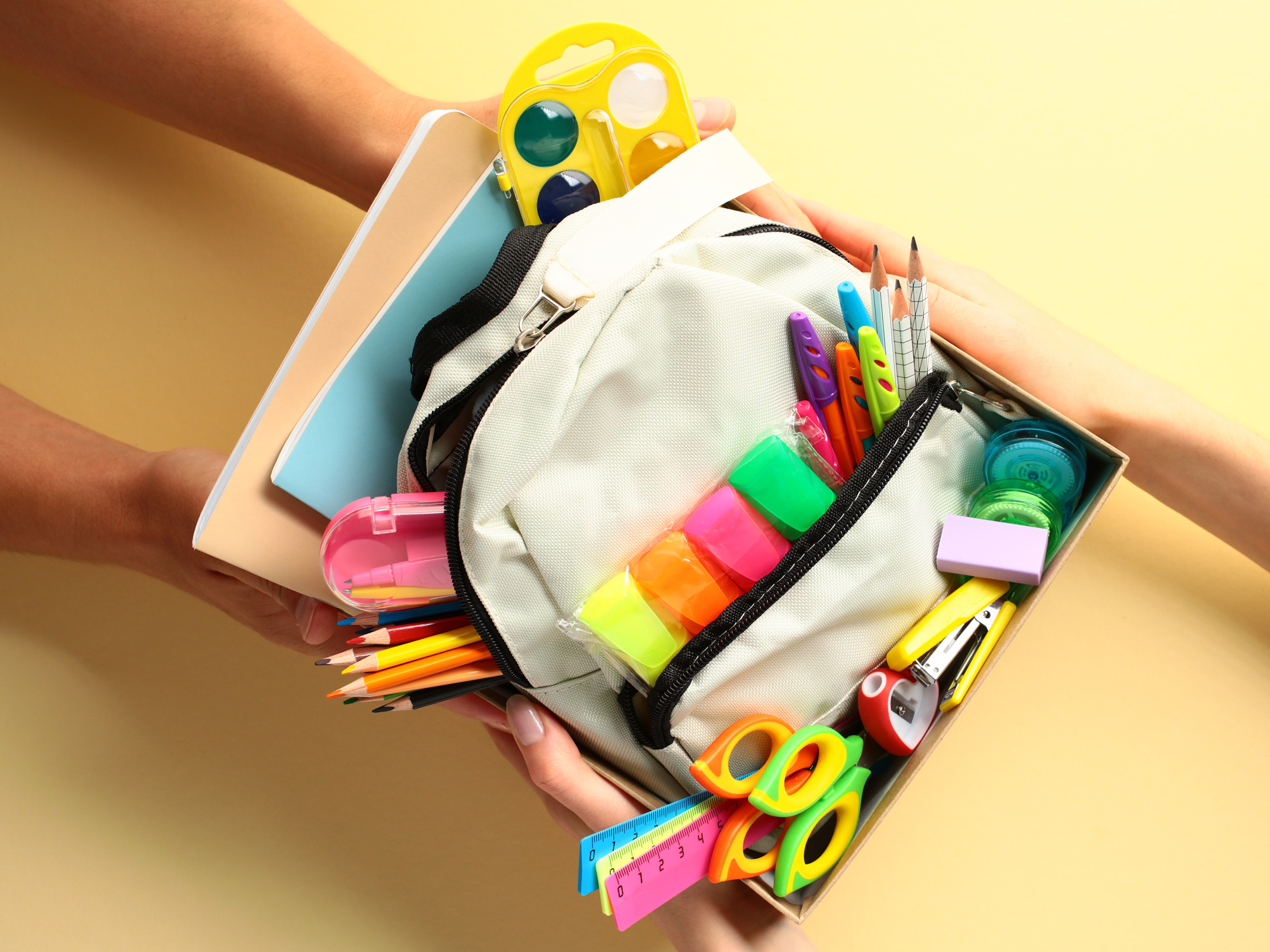 Image of a backpack with brightly colored school supplies