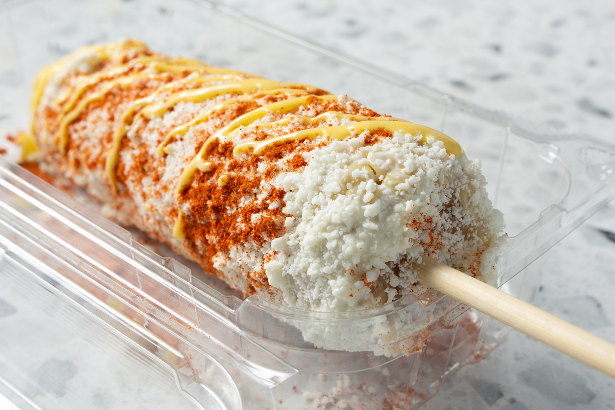 Elote with sauce and powdered toppings